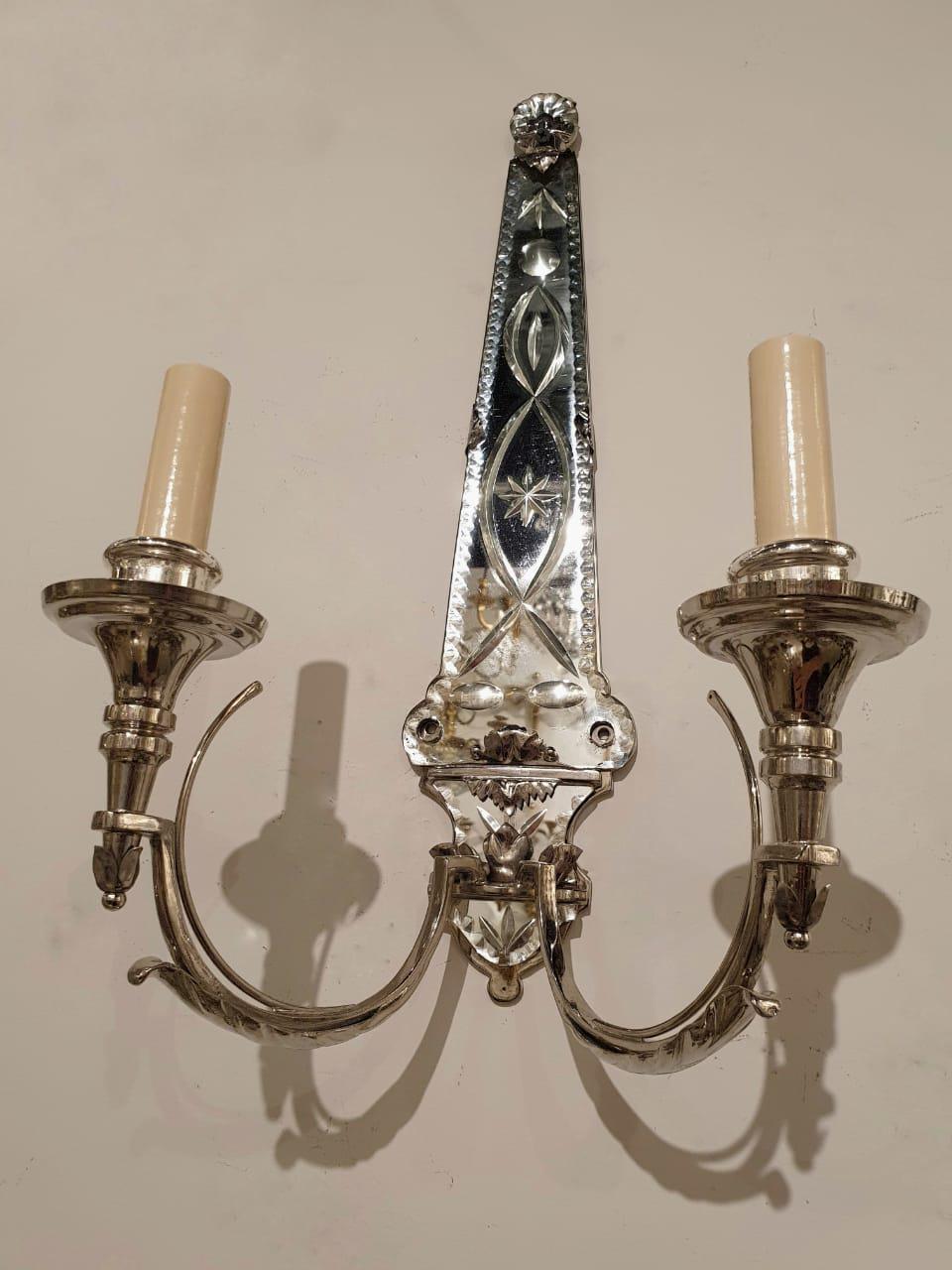 A pair of circa 1920’s silver plated and etched mirror sconces with two lights. Available in bronze color 