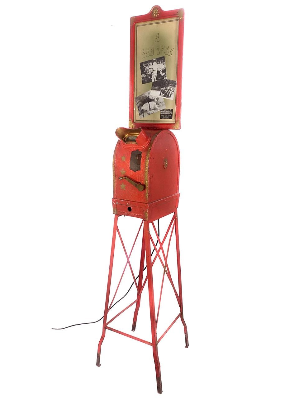 This is a nice working Mutoscope from the early 20th century. It is unrestored and in nice working order. The paint and red/gold paint patina is too nice to repaint. We like it just as it is. The movie reel is called 