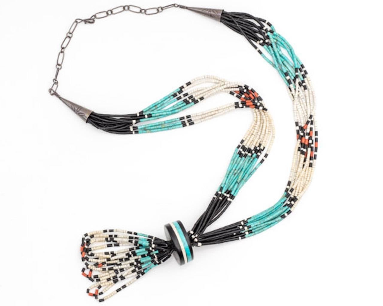 Sterling Silver, Turquoise, Onyx, Coral Necklace 

This 34 inch long necklace features natural stone beads including Turquoise, Onyx and Coral. Navajo Nation artists of Southwestern America arranged these natural stones into a beautiful design. The