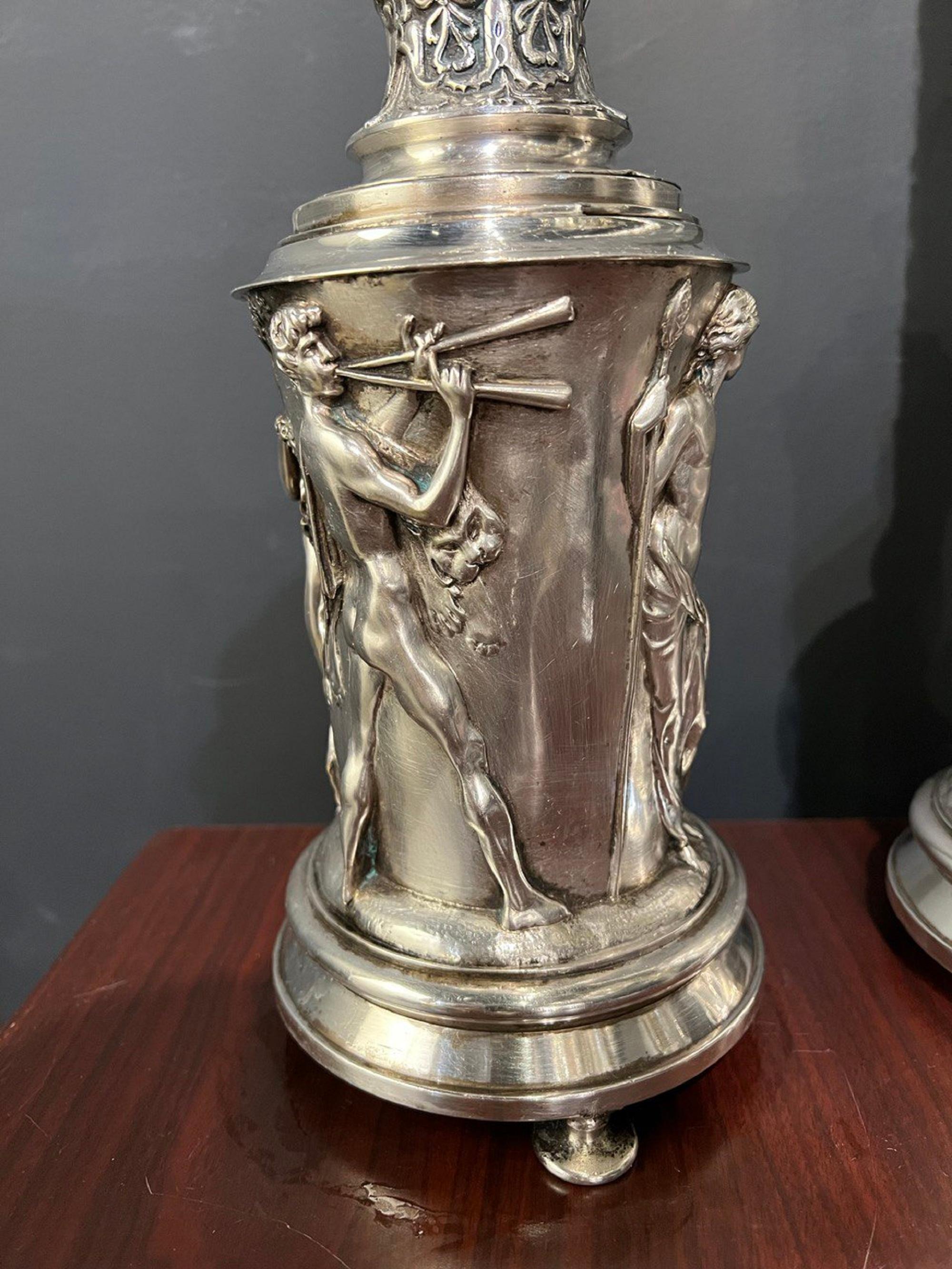 The circa 1920s neoclassic Greek style Caldwell silver table lamp with a lot of details: people body on bottom part and leaves on top