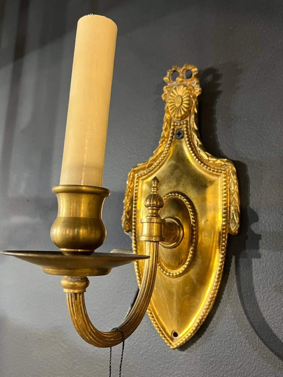 A pair of 1920’s gilt bronze sconces neoclassic style with one light 