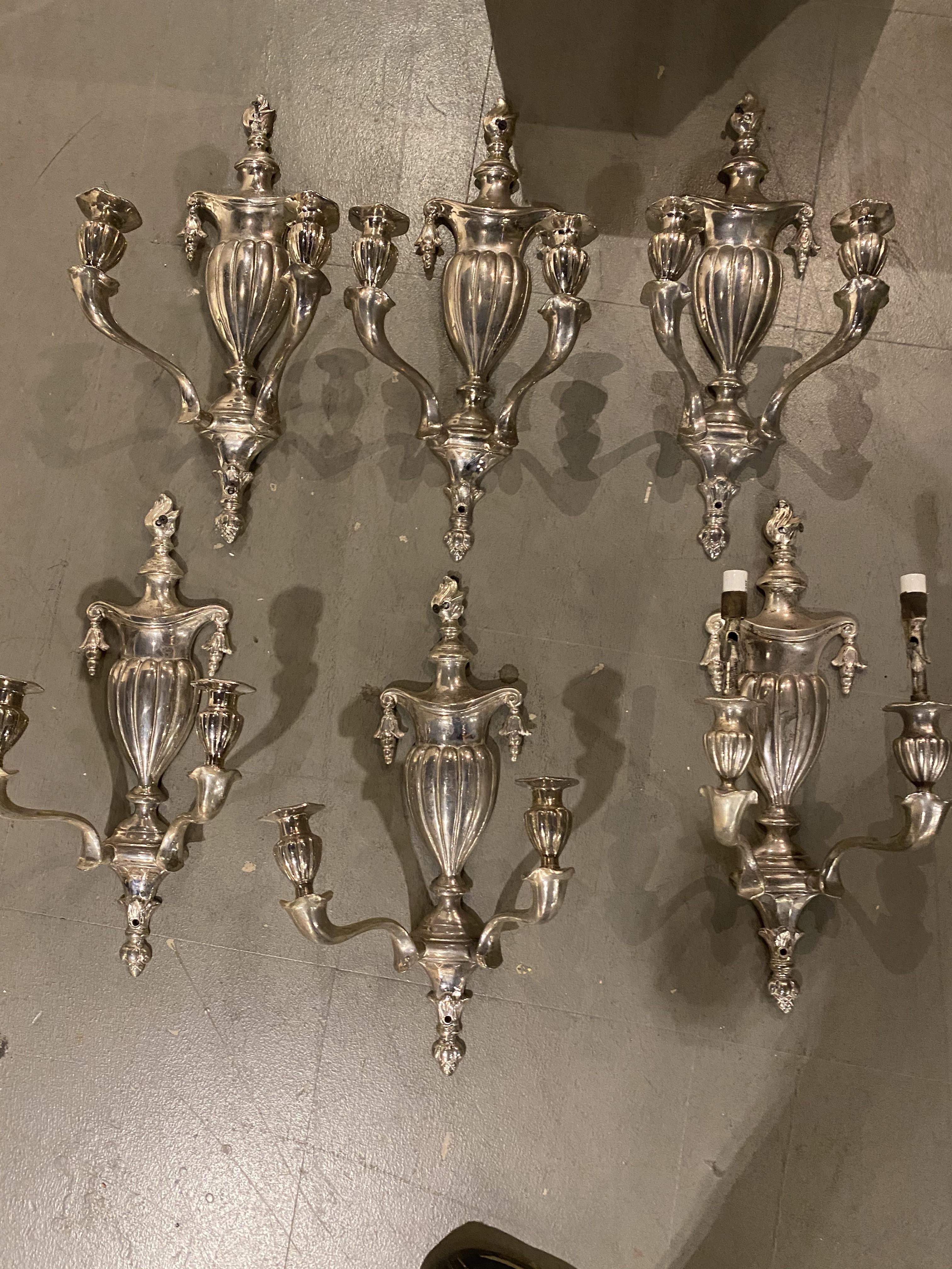 A pair of circa 1920’s neoclassic style silver plated sconces with two lights 