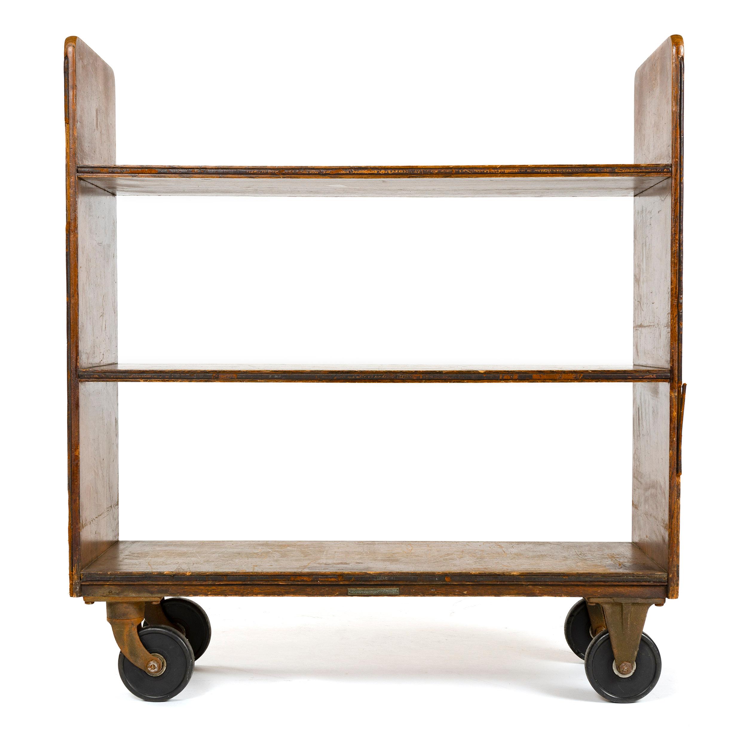 A mission, utilitarian style mobile shelving unit manufactured by the ‘Library Bureau SoleMakers’ company that pioneered and specialized in furnishings specifically designed for use in public and institutional libraries during the first three