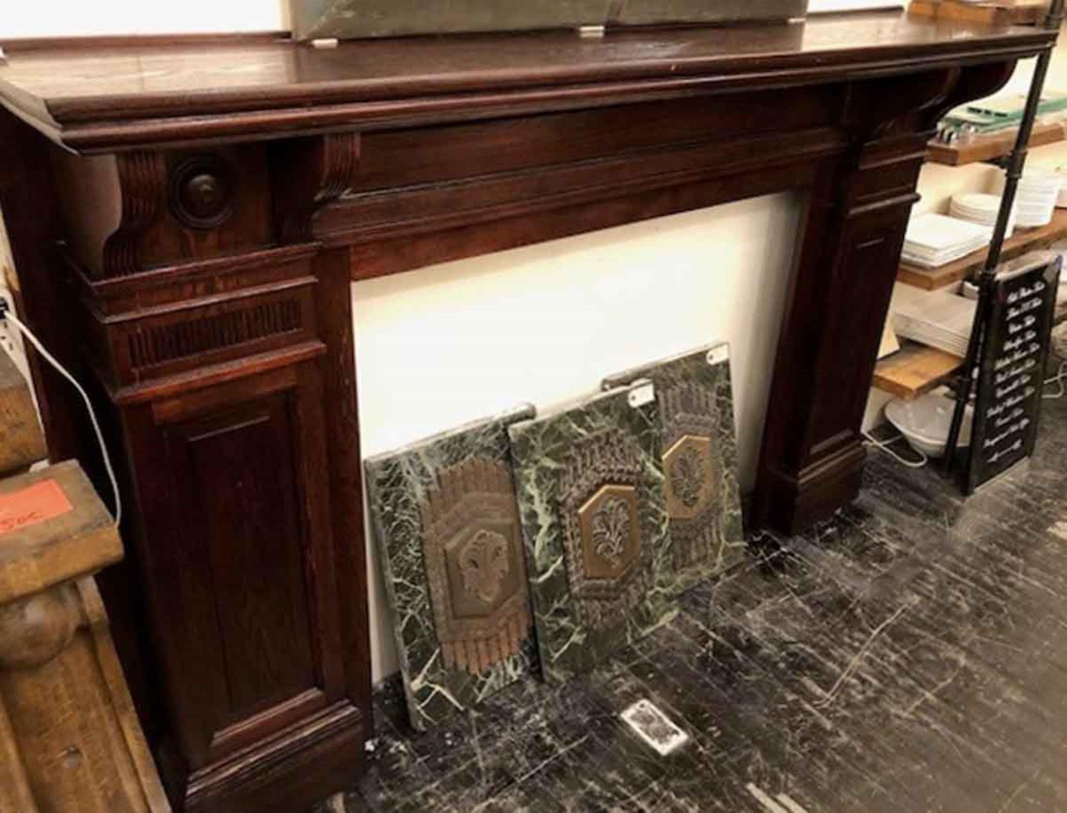 1920s dark stained oak mantel with simple lines and bulls eye details. This was reclaimed from a residence on West 85th St in Manhattan. This can be seen at our 302 Bowery location in NoHo in Manhattan.