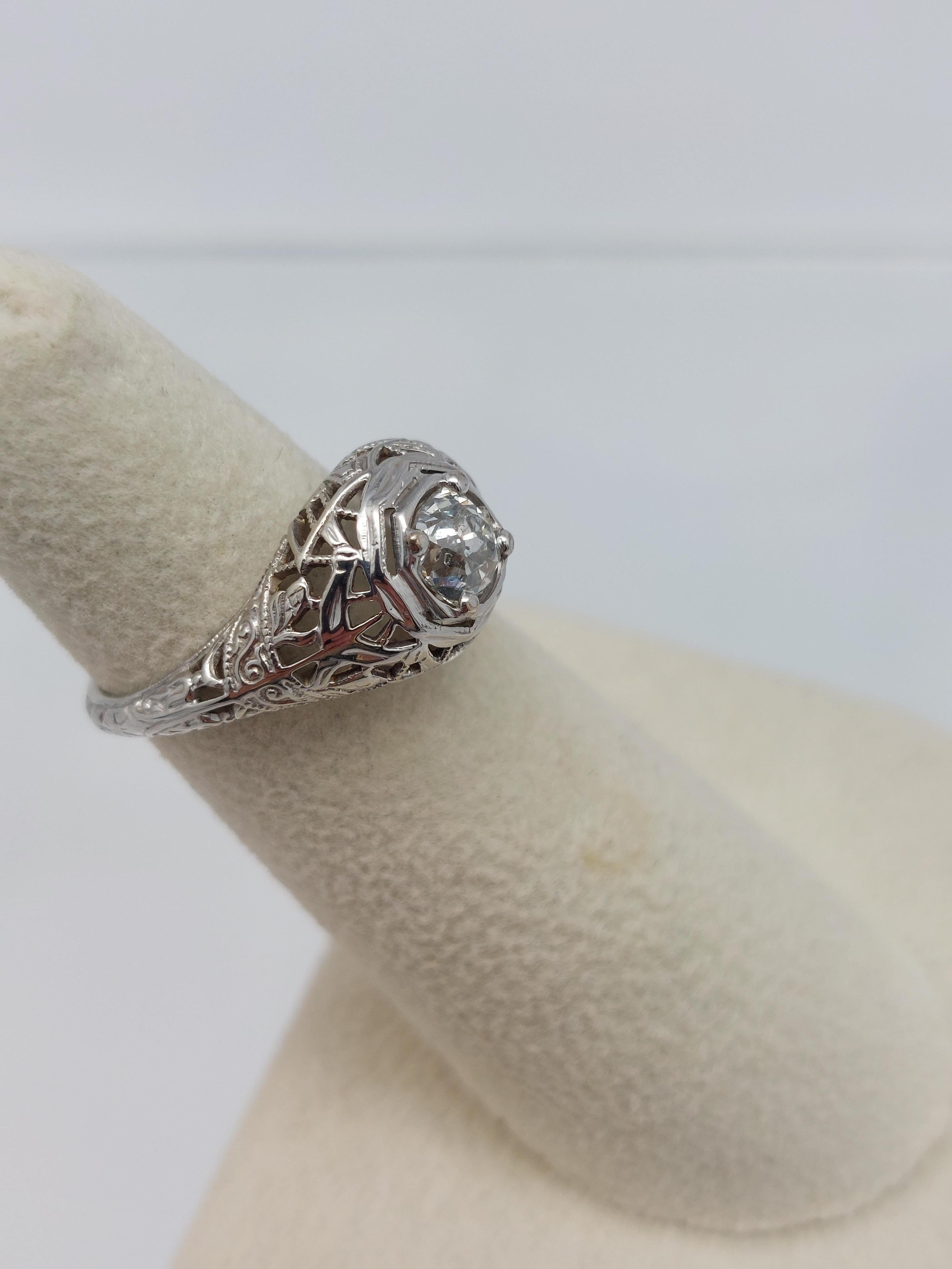 Old World engagement  Ring................
18Kt White Gold Filigree Old European Cut Diamond Ring.
One Old European Cut measuring  5.60 x  5.45 x 3.83 m.m., weighing approx.  0.67 carat.
Diamond is colorless, I clarity.
Lovely filigree work encasing