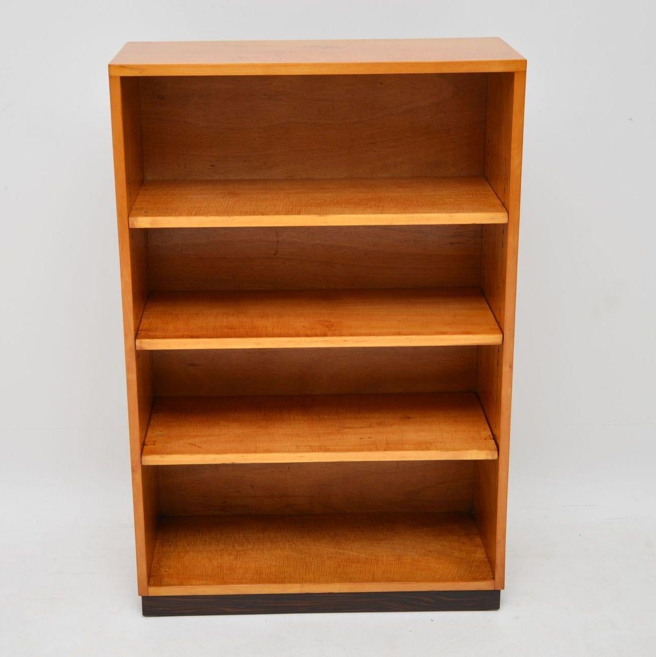 A stylish and extremely well made original Art Deco period bookcase dating from the 1920s-1930s. This is predominantly in beautiful satin birch, even on the inside and shelves; it sits on a rosewood base. We have had this fully stripped and