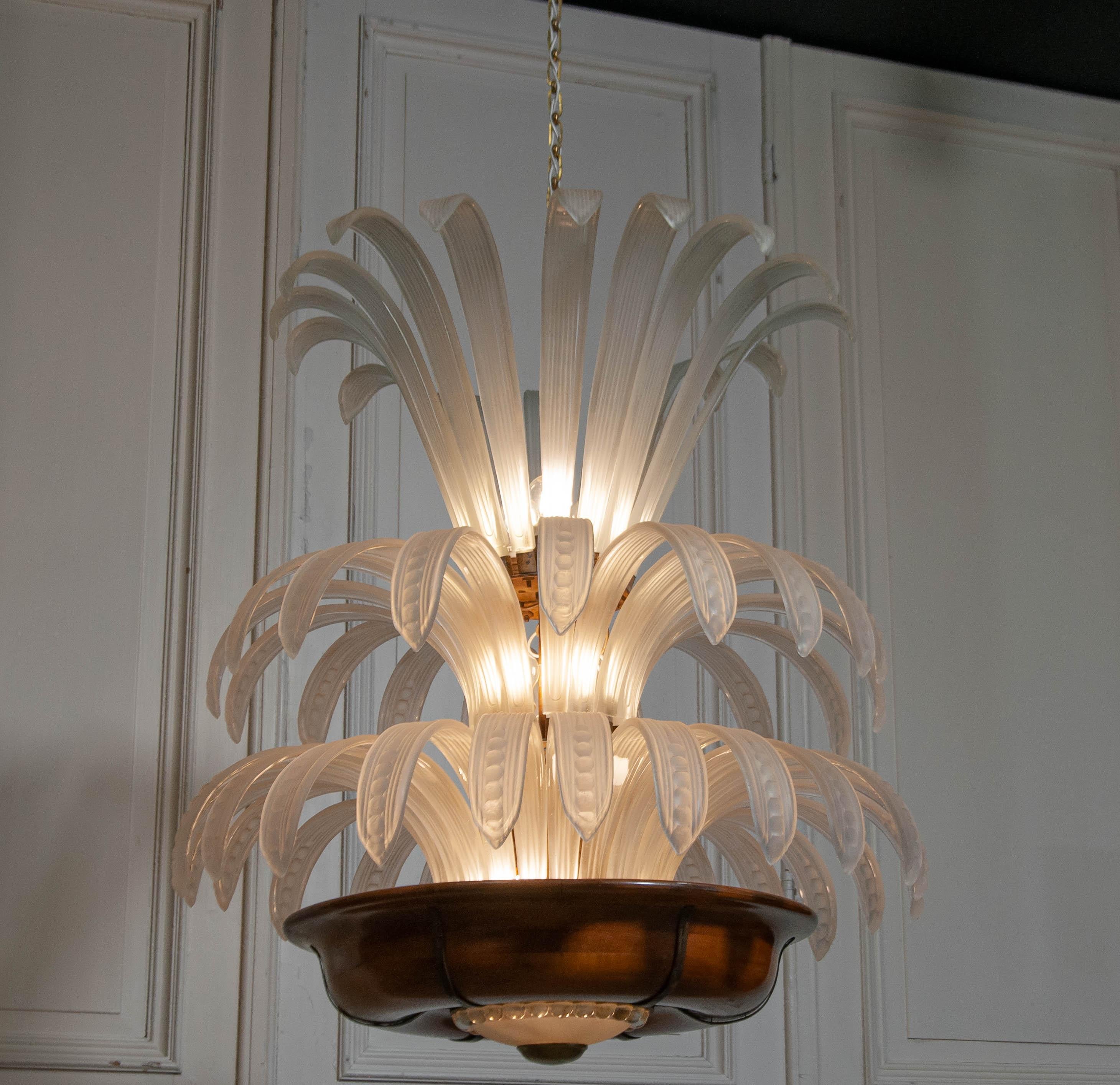 Original 1920s Belgian chandelier in complete and authentic condition, crafted in the Art Glass tradition. This exceptional piece features delicately molded frosted glass elements arranged in a striking palm motif, creating an elegant, sculptural