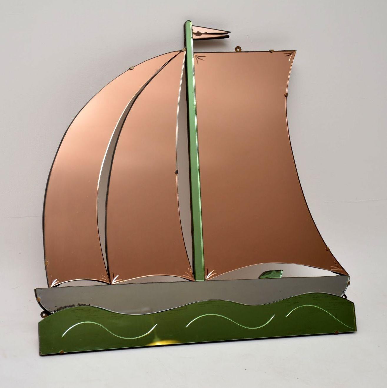 An absolutely stunning and very unusual vintage Art Deco period mirror in the shape of a boat, this dates from the 1920s-1930s. It's in excellent original condition, with just some incredibly minor wear to the silvered backing on one or two edges.