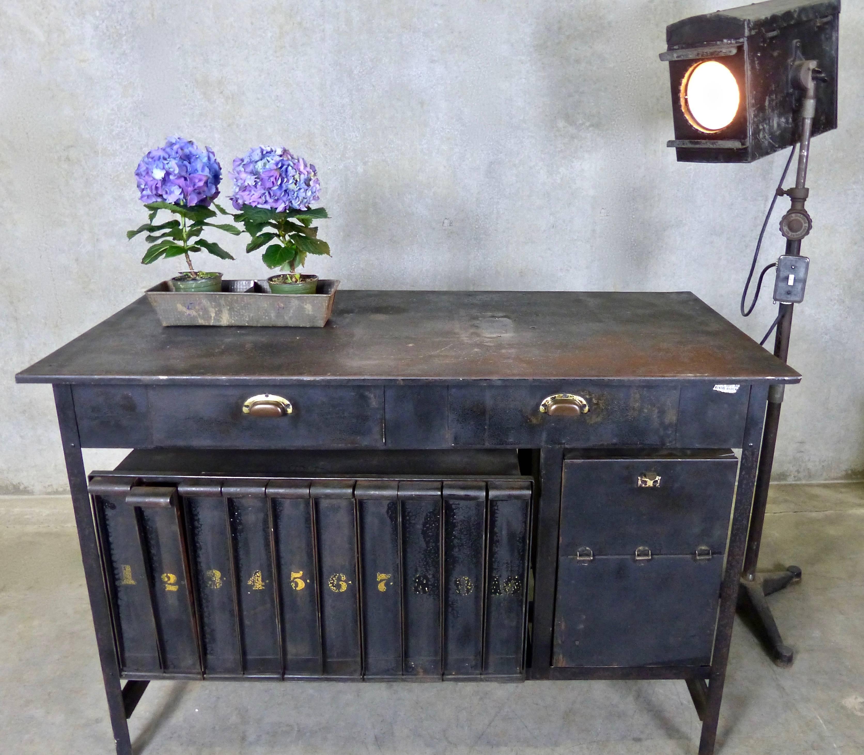Sourced from a projection booth in an institution in upper New York State, this antique metal film rewind table include individual, angled storage slots for ten reels or canisters of film.
A must have object for film buffs.