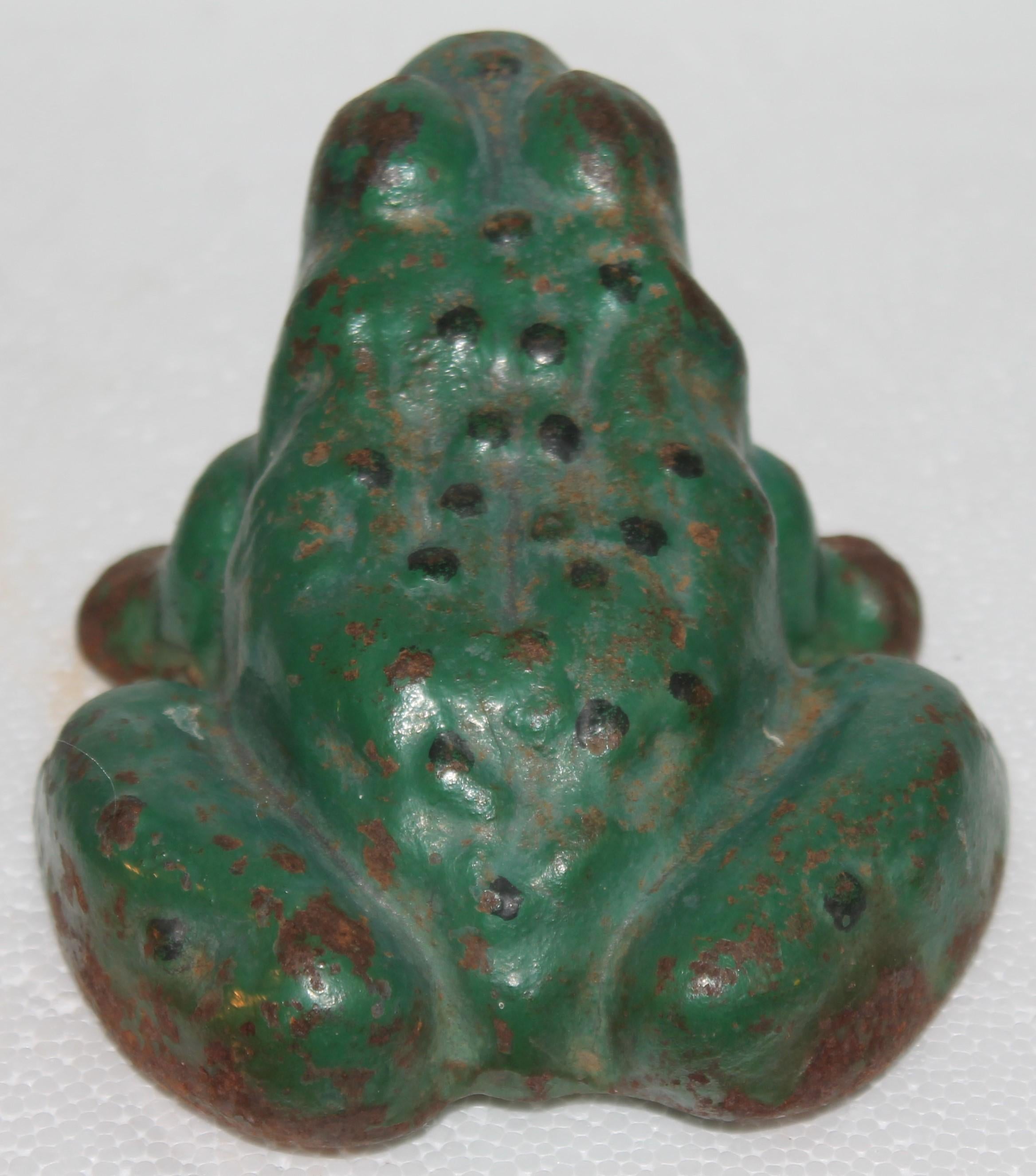 1920's original painted iron frog doorstop. Painted green body and yellow belly.
The frog can also be used as a Garden Ornament.