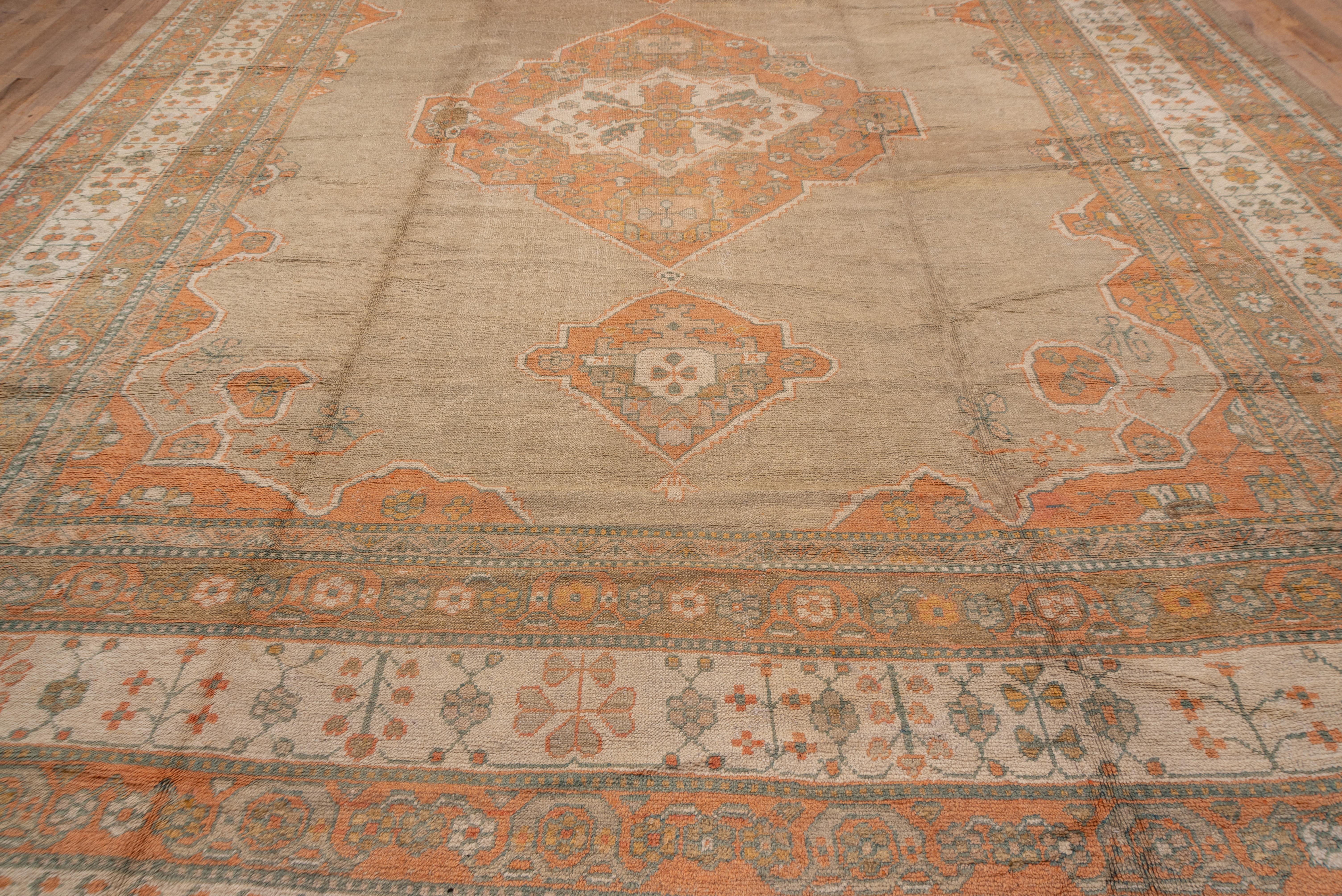 Wool 1920s Oversized Antique Turkish Oushak Carpet, Neutral Field, Orange Borders For Sale