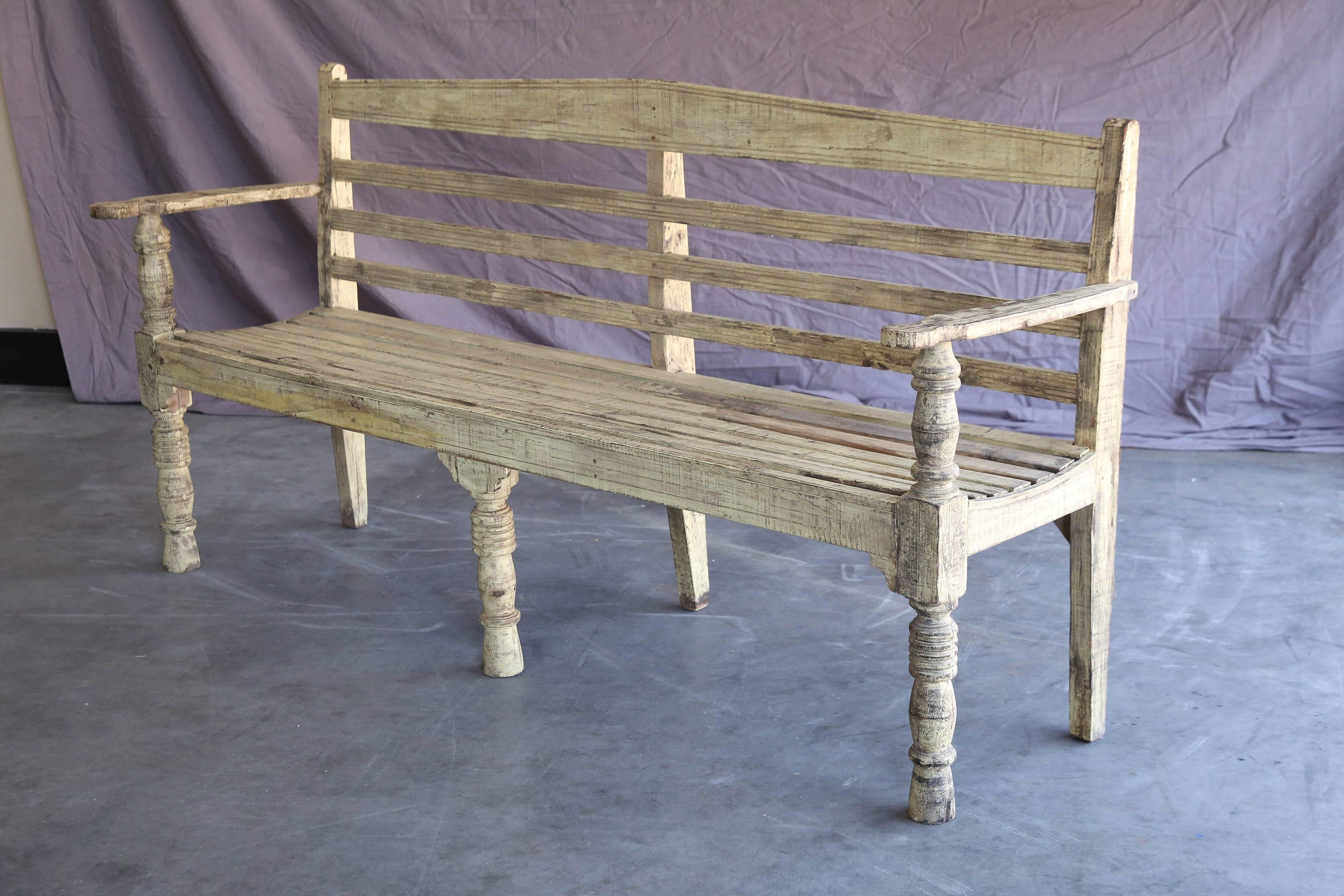 This bench is handcrafted in mahogany wood and painted in white to blend with the large open hall that used to display the cream of the harvests every year. It is supported on six legs and is solid like a rock. Meant to last several generations. A