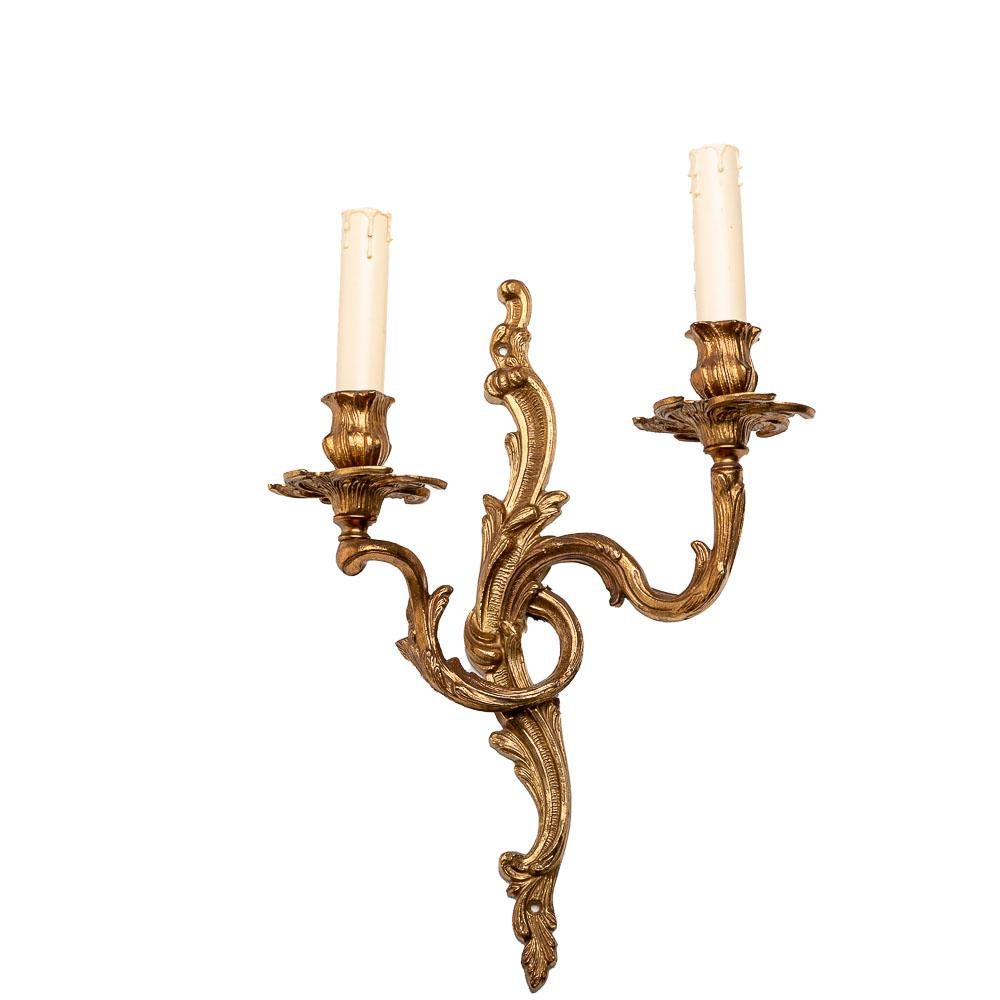 French gilded and chiseled bronze wall lights, made in Louis XVI style. Two Edison 14 bulbs and candle covers. 
In full working condition and ready to use. Equipped with European wiring, it can support voltage up to 230v, which is commonly used in