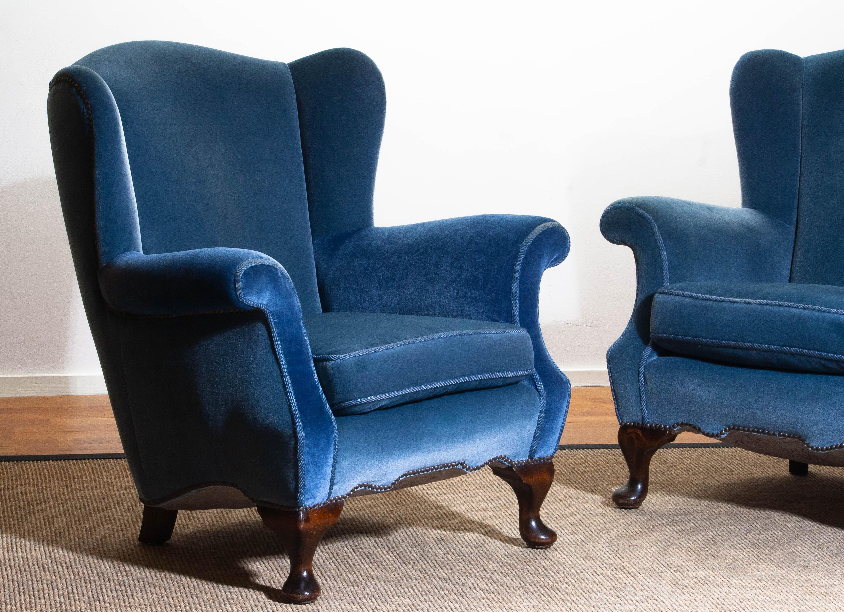 Unique set of two extremely beautiful Swedish club chairs in blue velvet from the 1920s.
The chairs are completely restored in 1987 (only original materials are used) and after one of the chairs received
new velvet on the armrests. See