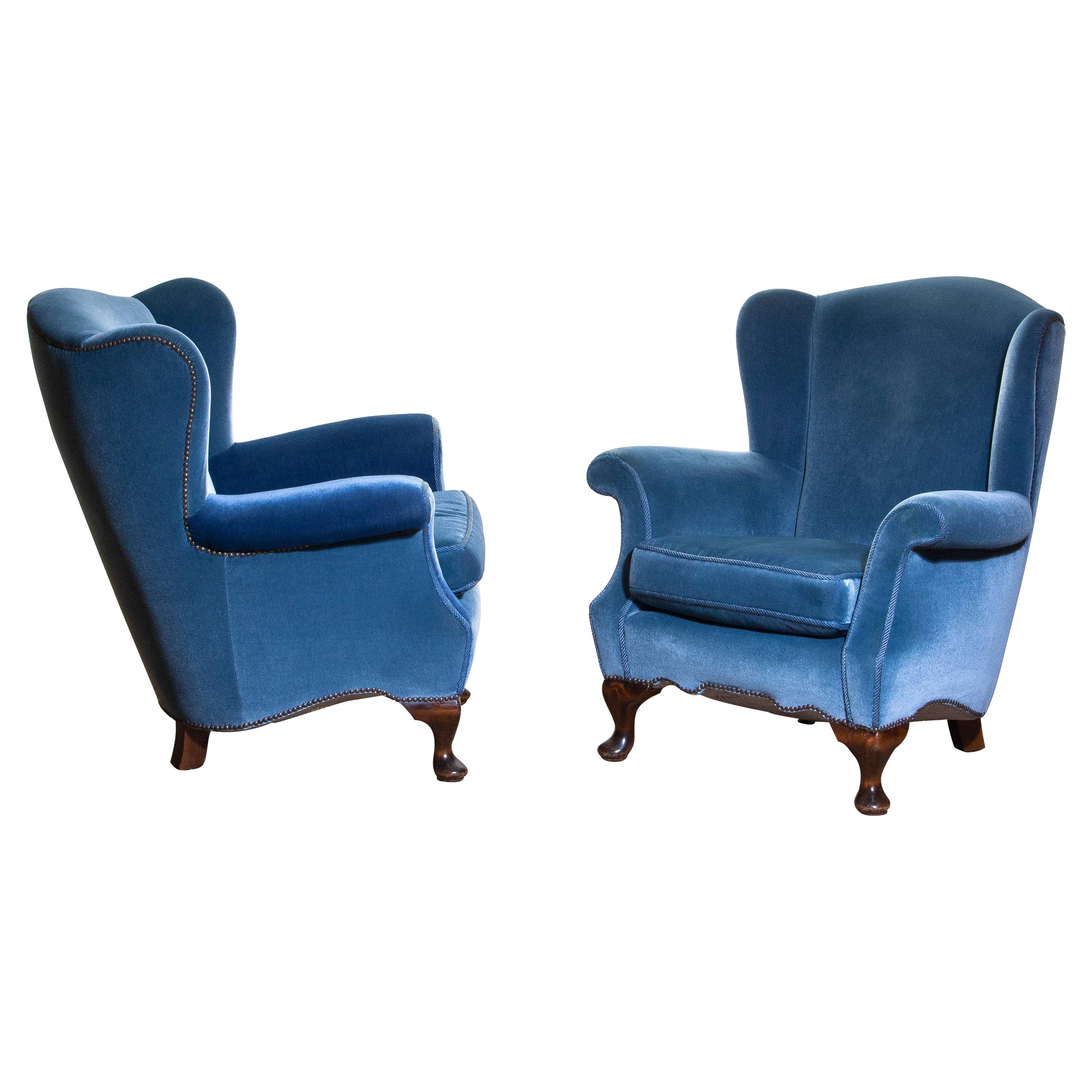 Unique set of two extremely beautiful Swedish club chairs in blue velvet from the 1920s.
The chairs are completely restored in 1987 (only original materials are used) and after one of the chairs received
new velvet on the armrests. See