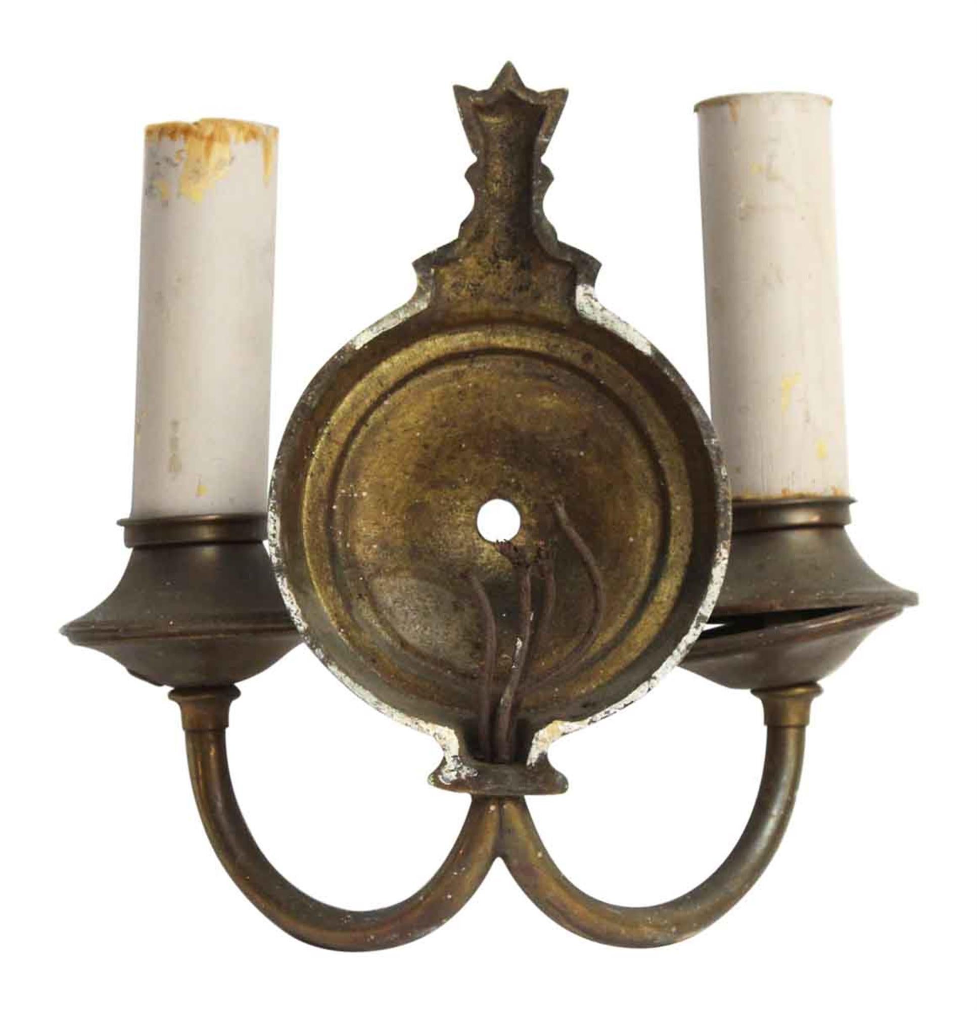 Simple brass sconces with an antique brass finish, circa 1920. Priced per pair. Several pairs available at time of posting. This can be viewed at our Scranton, Pennsylvania location. Please inquire for the exact address.