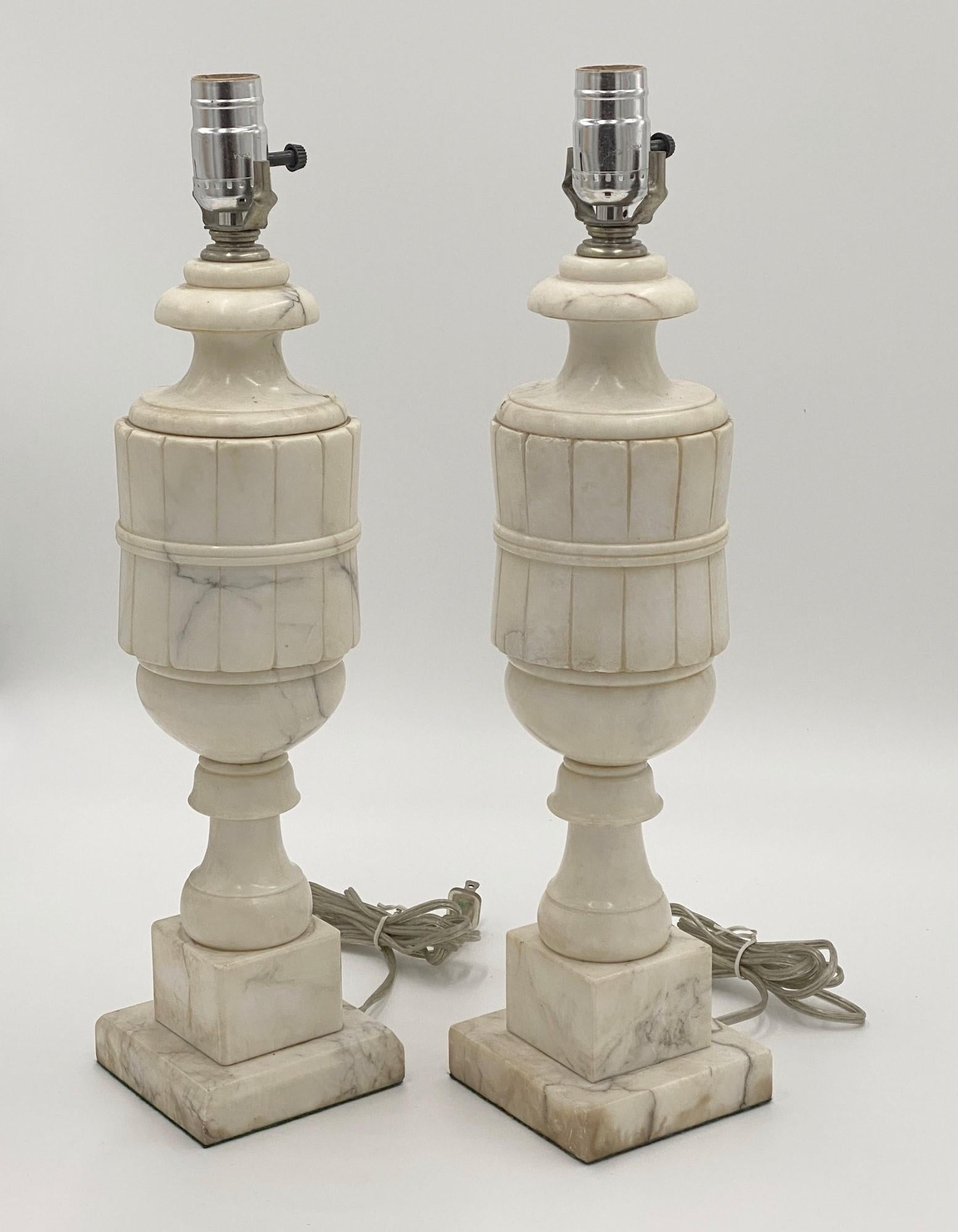 1920s table lamps carved out of alabaster. Sold as a pair. This can be seen at our 333 West 52nd St location in the Theater District West of Manhattan.