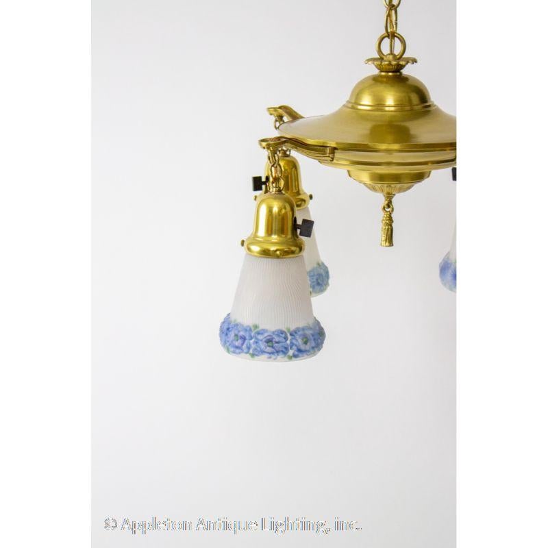 Classic pan light, hand polished brass with four hanging lights. Original glass shades are frosted with blue painted flowers.

Material: Brass, Glass
Style: Traditional
Place of Origin: United States
Period Made: Early 20th Century
Dimensions: