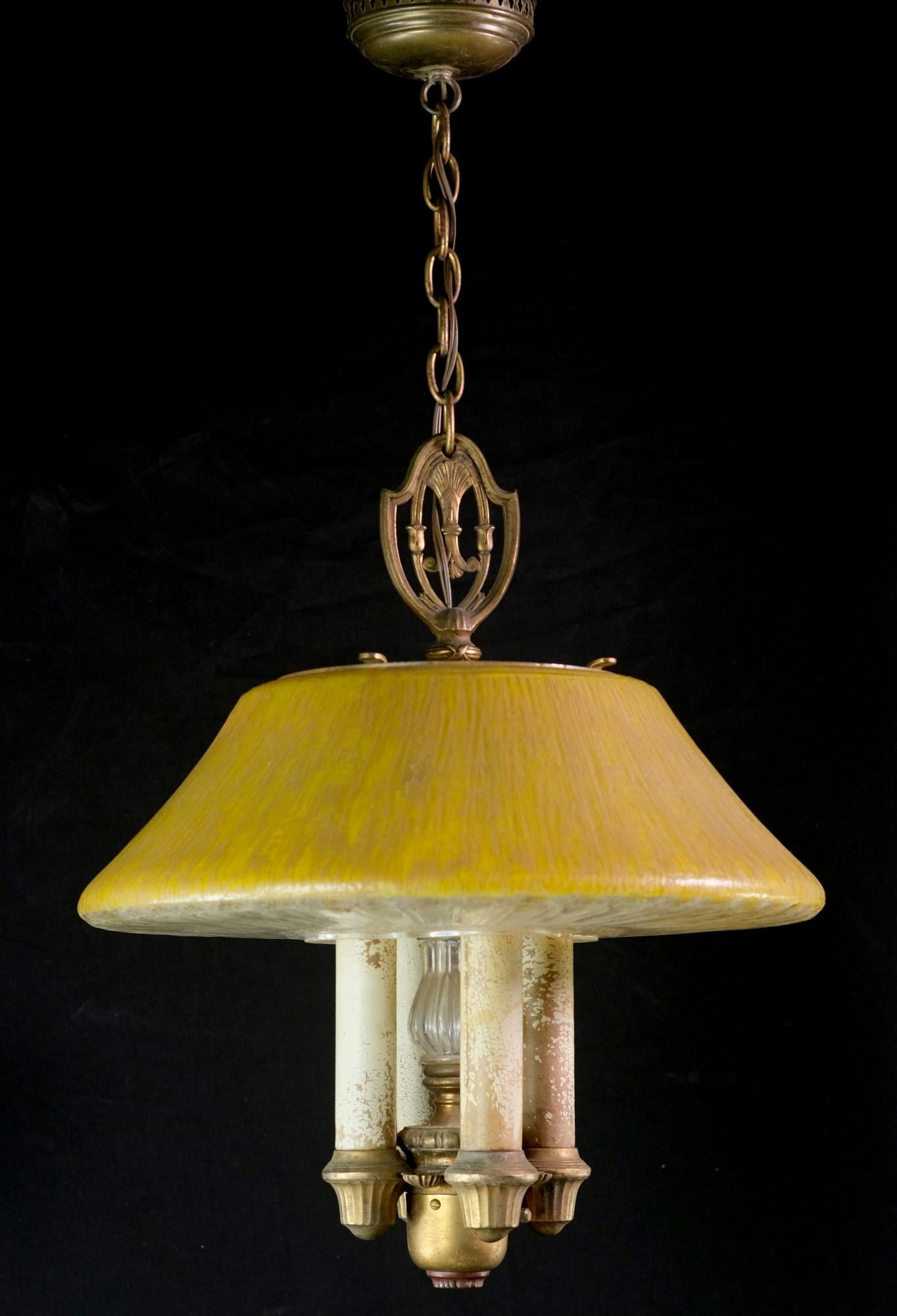 A cast yellow glass mushroom shaped shade adorns this four candlestick pendant light. Features bronze plated steel hardware. Made by Lightolier. Accepts four E26 light bulbs. This can be seen at our 400 Gilligan St location in Scranton, PA.