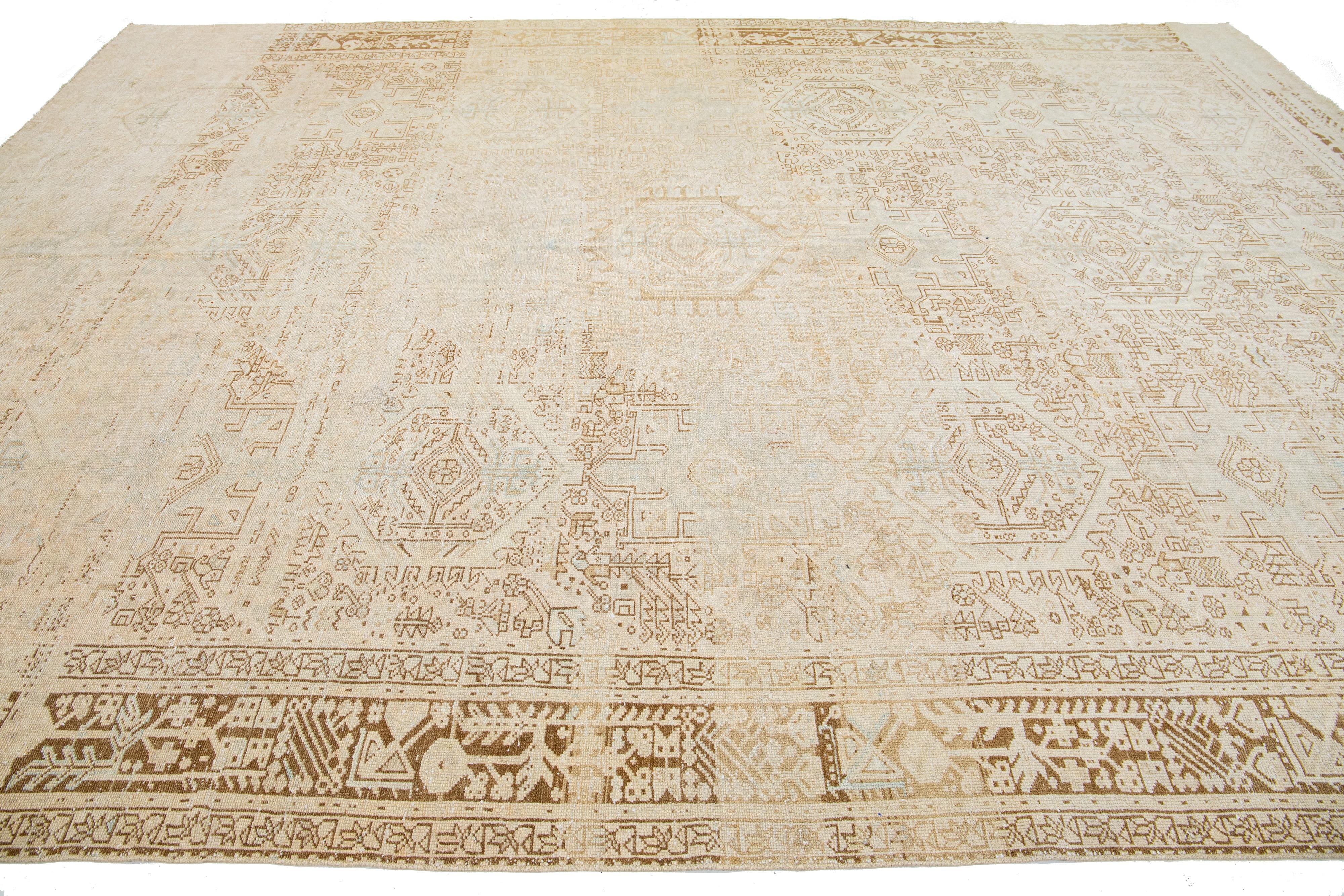 Hand-Knotted 1920s Persian Antique Heriz Wool Rug with a Design Featuring Muted Tones For Sale