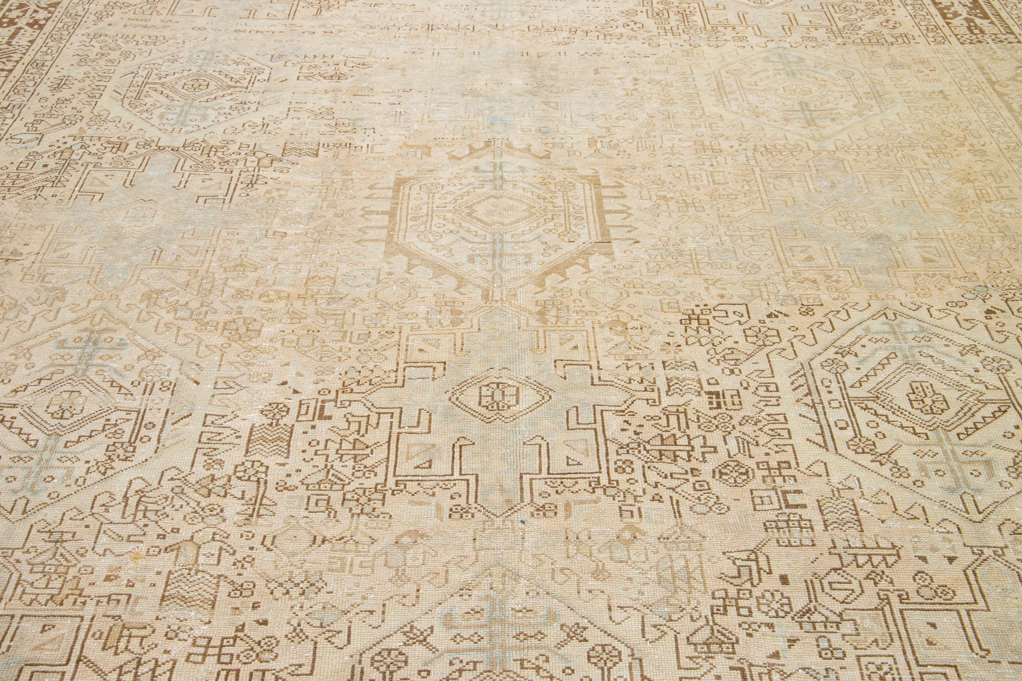 Early 20th Century 1920s Persian Antique Heriz Wool Rug with a Design Featuring Muted Tones For Sale