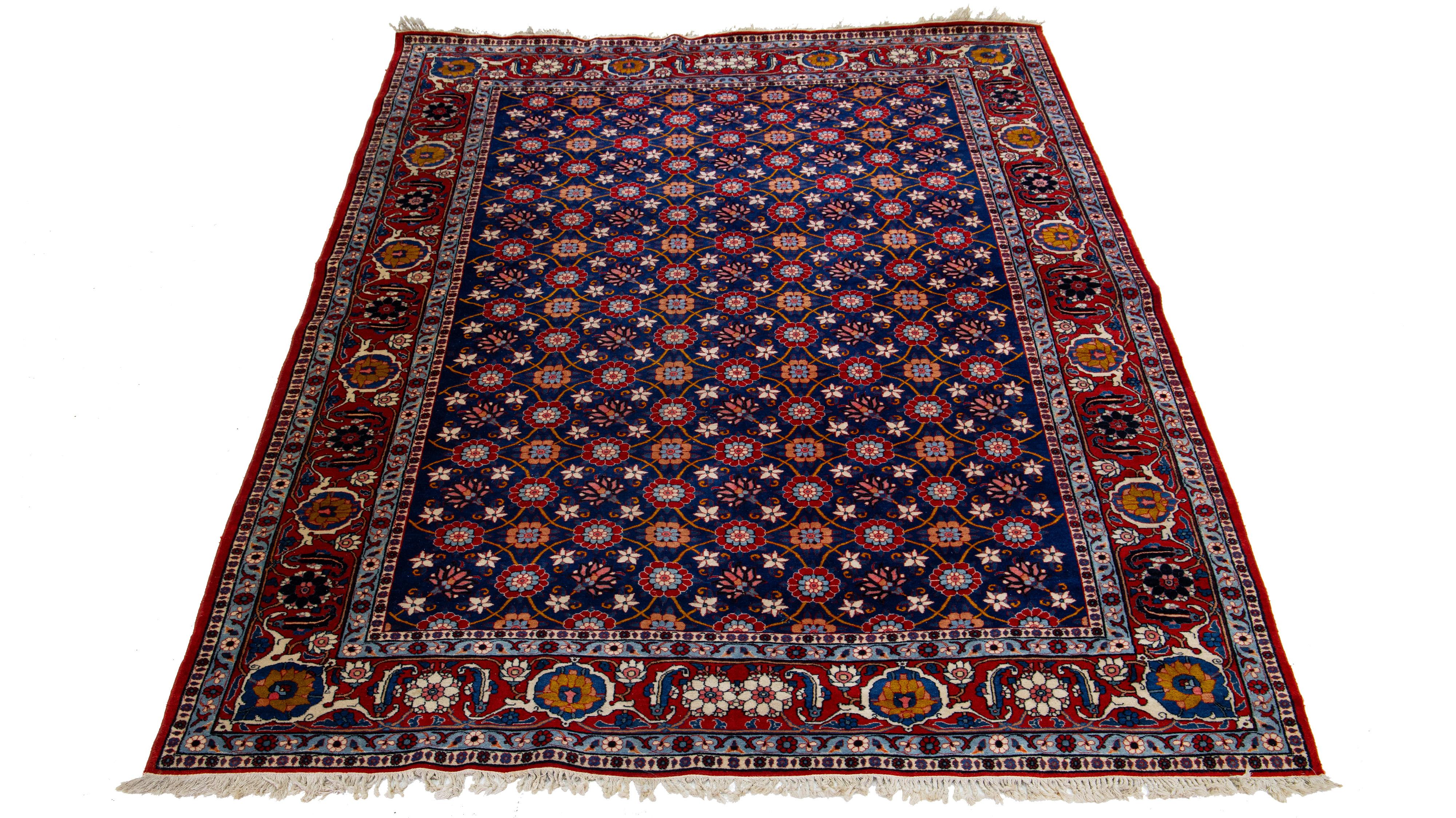 The meticulously handmade Persian Tabriz woolen rug, dating back to the 1920s, exhibits a striking, classical floral motif. An audacious multi-hued blend enhances the design, contrasting the rug's bold blue backdrop.

This rug measures 7'3