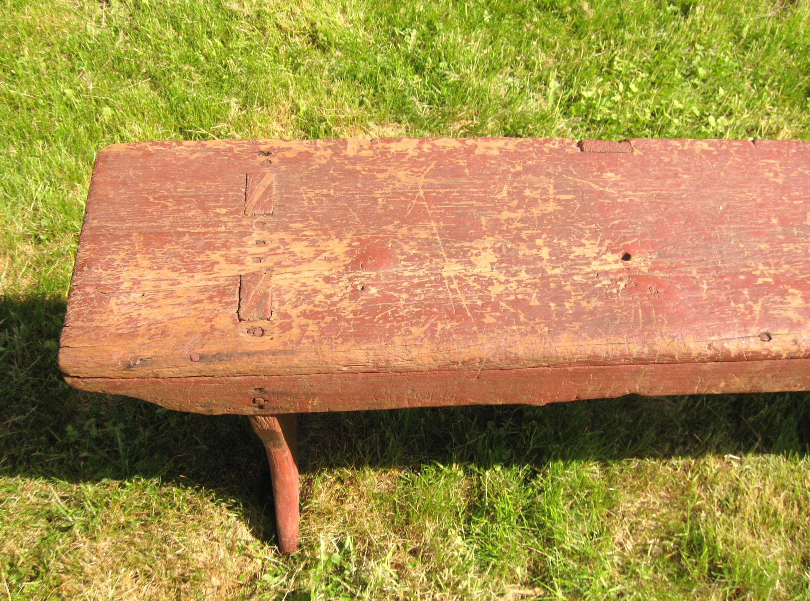 This is a wonderful 1920s pine bench, it has been painted a wonderful barn red. It is mortised and it shows a lot of natural wear. It has been yet well used, and still has a Lotta use left. Another true antique piece that came out of my historic