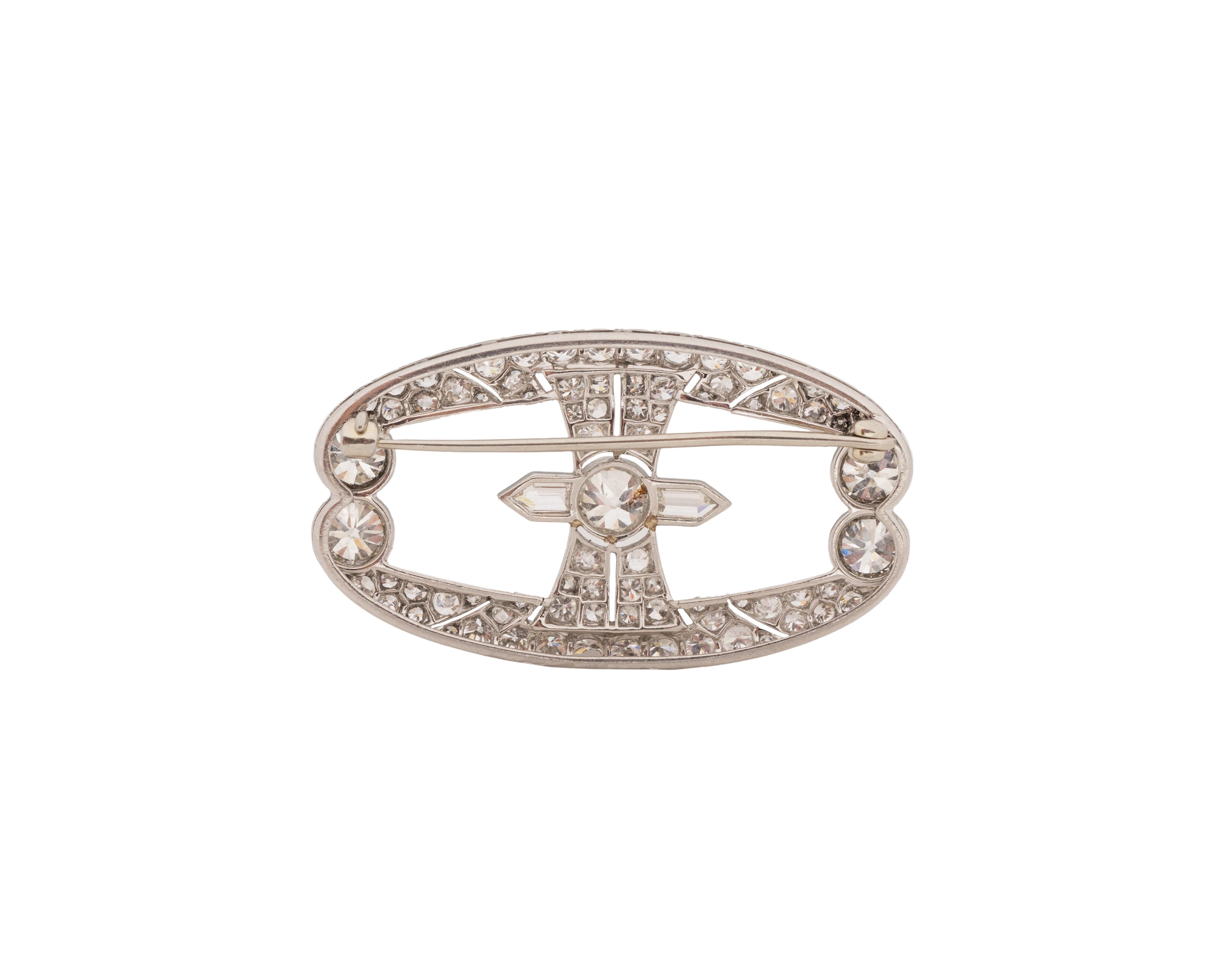 An exceptional and authentic Art Deco brooch. Featuring the quintessential vintage European cuts. Featuring some of the purest white in color antique cuts we have come across and unique shape stones flanking the center stone. A true antique one of