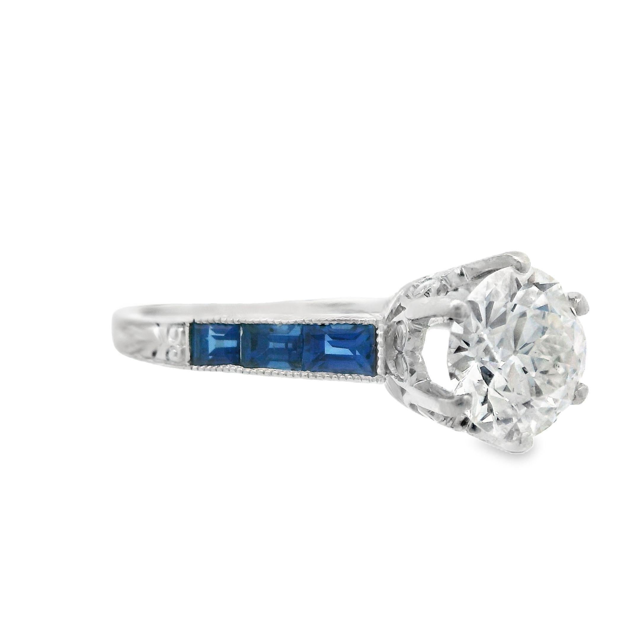 This beautiful ring from the 1920s Art Deco period is made in platinum with both natural sapphire and natural white diamond. The centerstone of this ring features a sparkly, bright-white and Euro cut diamond that will never go un-noticed. Each