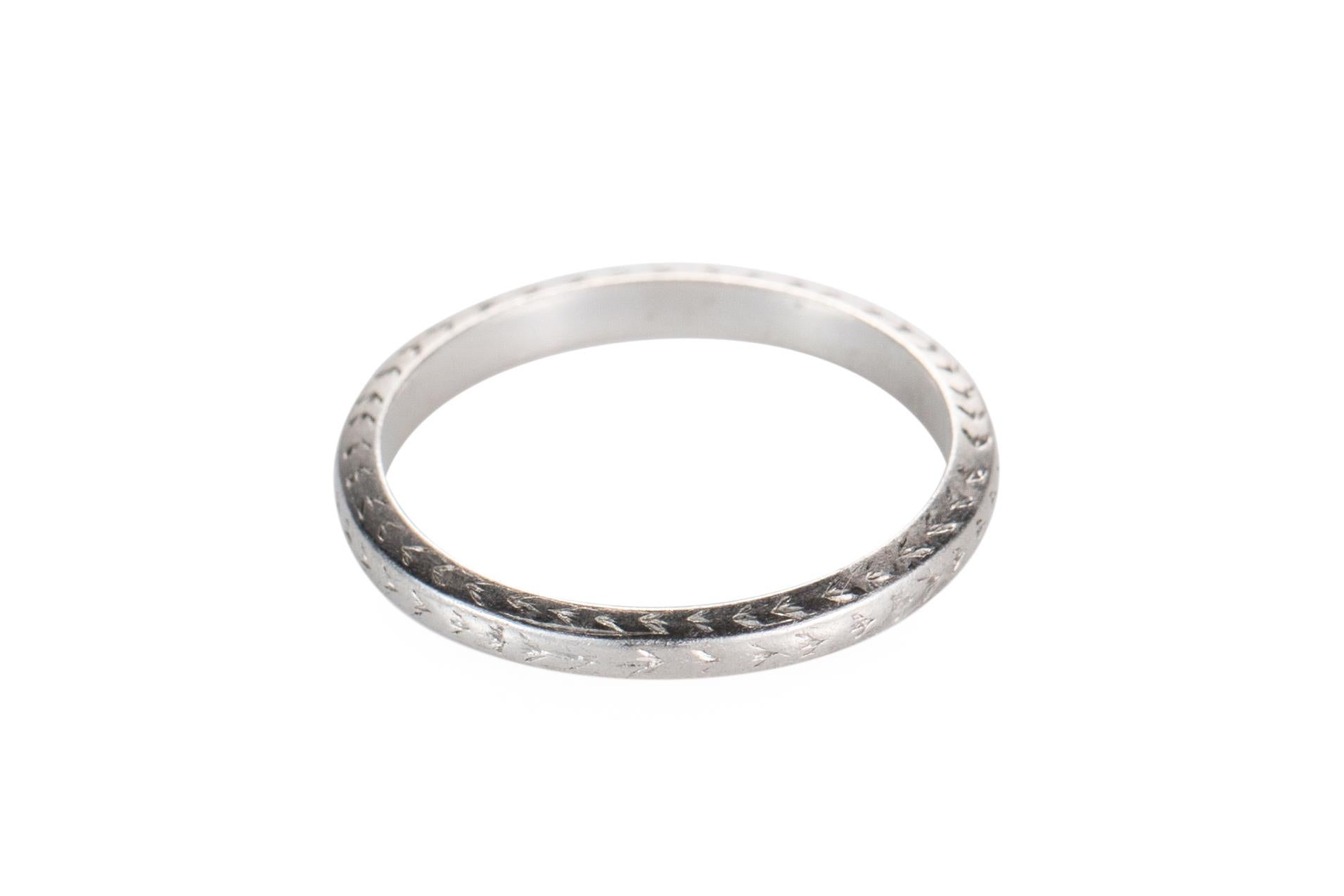 Item Details:
Metal Type: Platinum
Weight: 3 grams
Size: 7 (non resizable)

Absolutely stunning wedding band from the 1920s, art deco era. This ring is crafted entirely in platinum and features etching design work on the side profile and top. The