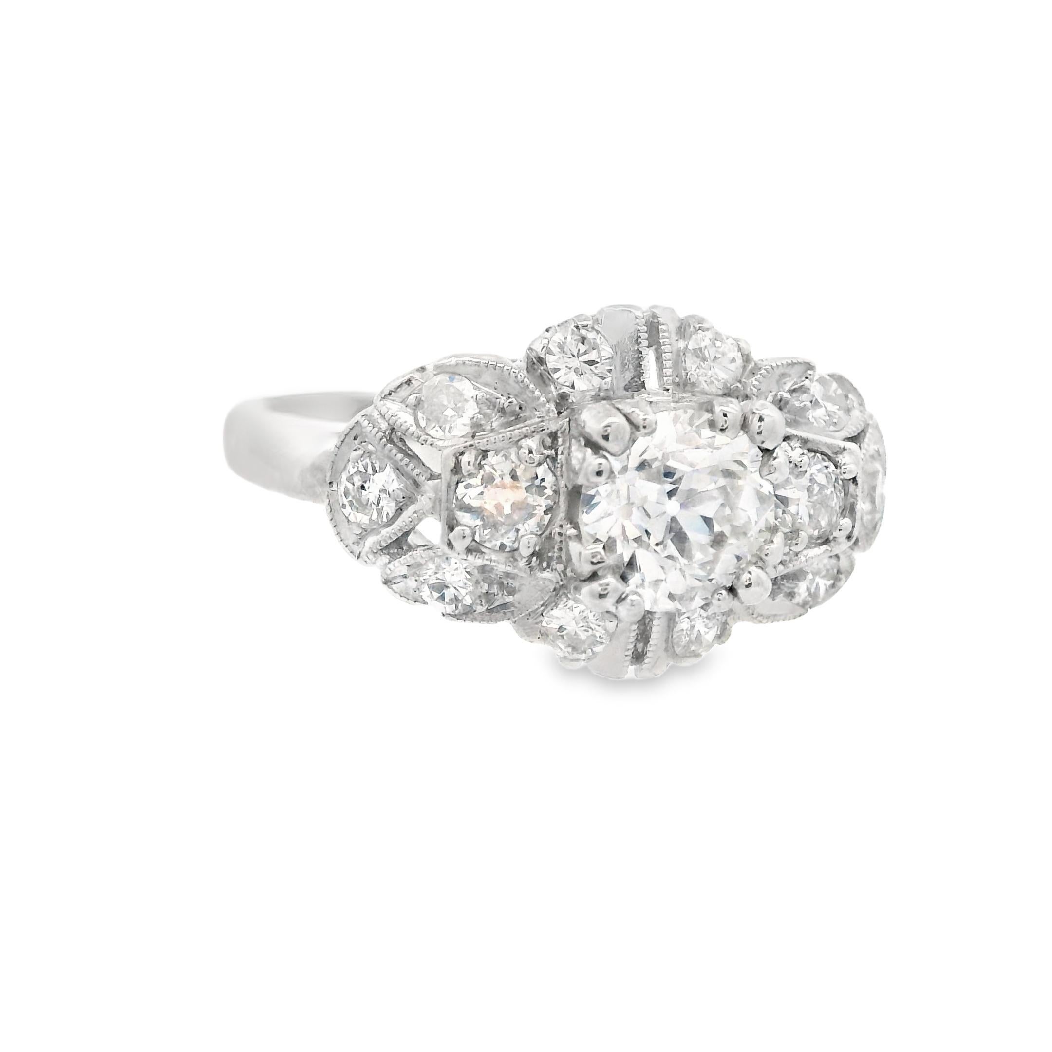 This is a stunning, bright white, European cut diamond engagement ring, made in platinum, from the 1920s. The centerstone of this ring is a .66 carat, G-H color, VS2 clarity Old European Cut diamond that delivers an eternal sparkle. To the left and