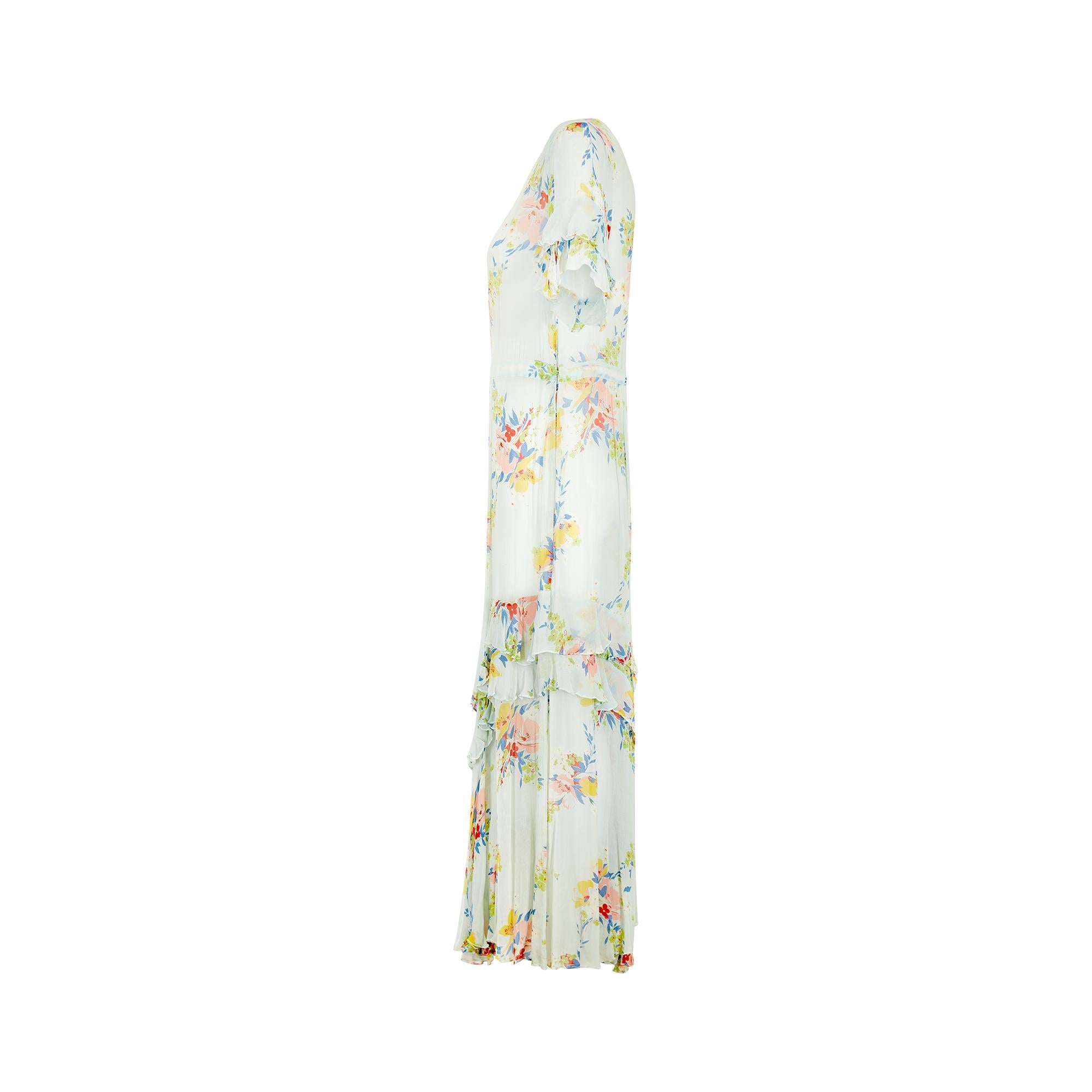 This 1920s ethereal antique tea dress is printed with florals in colours of the rainbow; peachy pink sits with red, lilac-blue, yellow and lime green, all against a gorgeous powder blue background. Falling to around ankle length, the