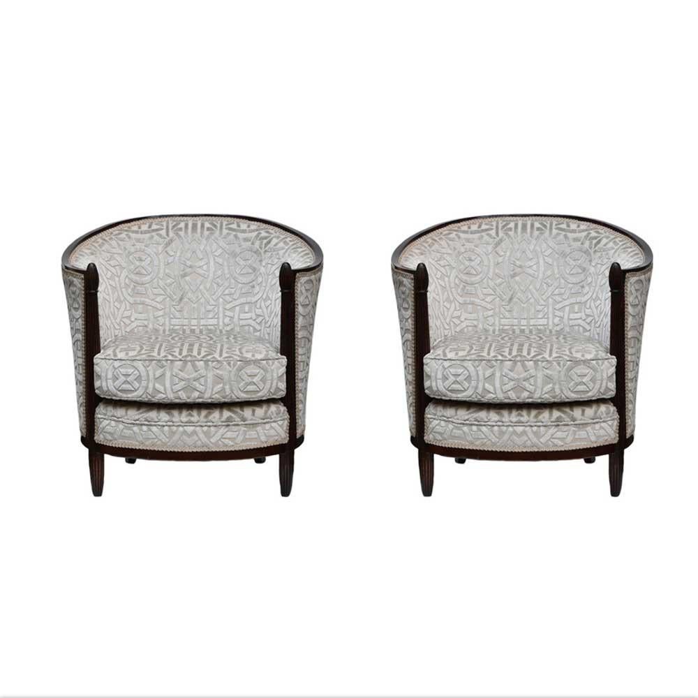 A 1920s rare pair of curved back armchairs. A fine example of French Art Deco. Round back, frame in dark chocolate brown ebony wooden structure, tapered carved legs , Ivory colour Velvet fabric with a pattern , newly upholstered respecting the