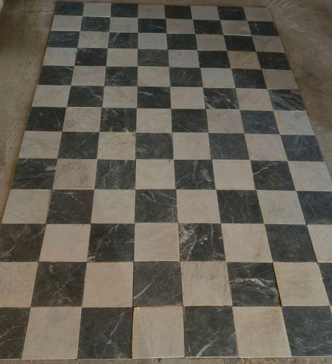 This is a 1920's piece by piece reclaimed Italian Carrara Bianco and Nero marble checker tile. The beautiful antique texture and the visible veining within this old marble flooring give it an absolutely gorgeous feel.

Such an item is only reclaimed