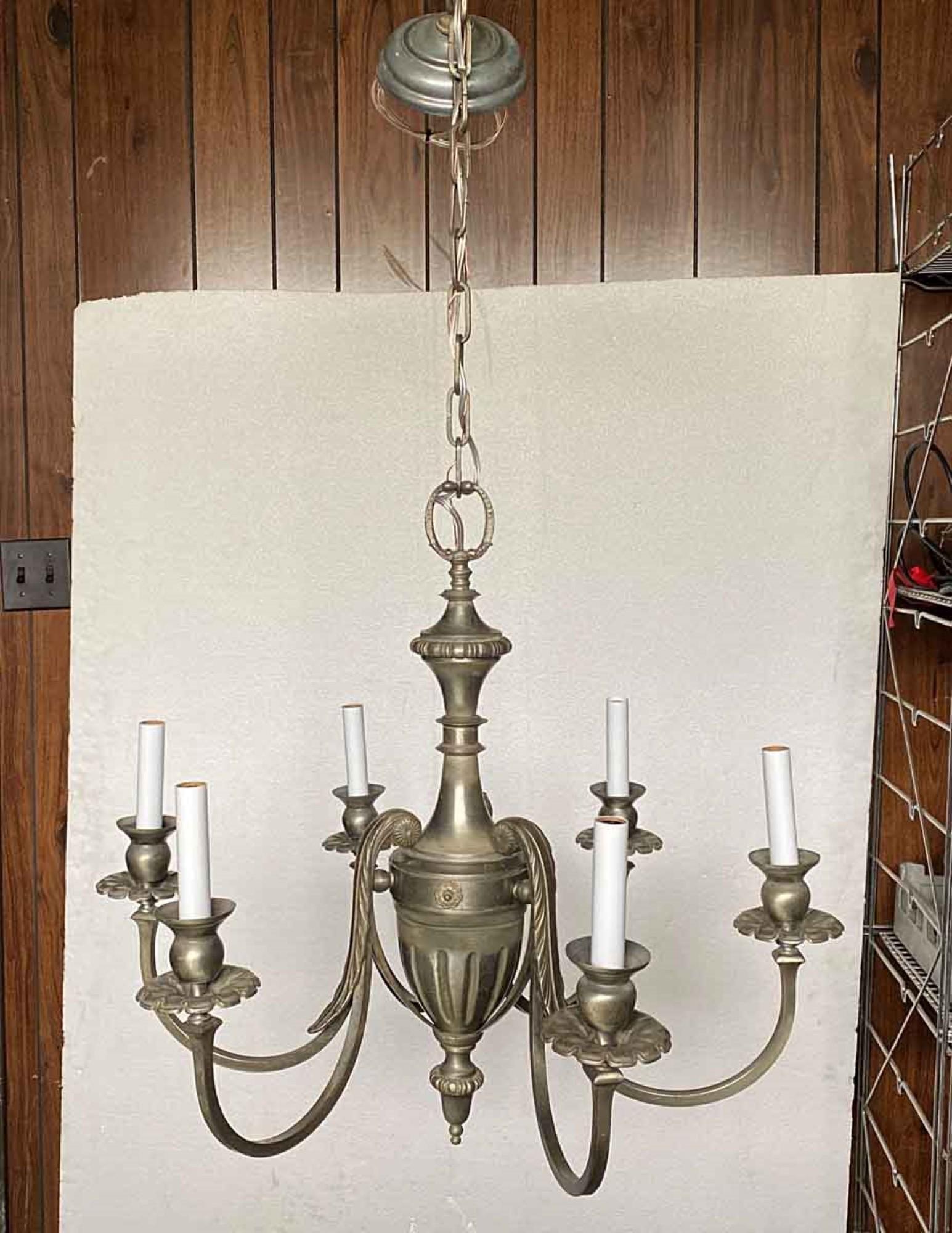 1920s Federal style brushed nickel over cast brass chandelier with six candelabra arms. This can be seen at our 400 Gilligan St location in Scranton, PA. 