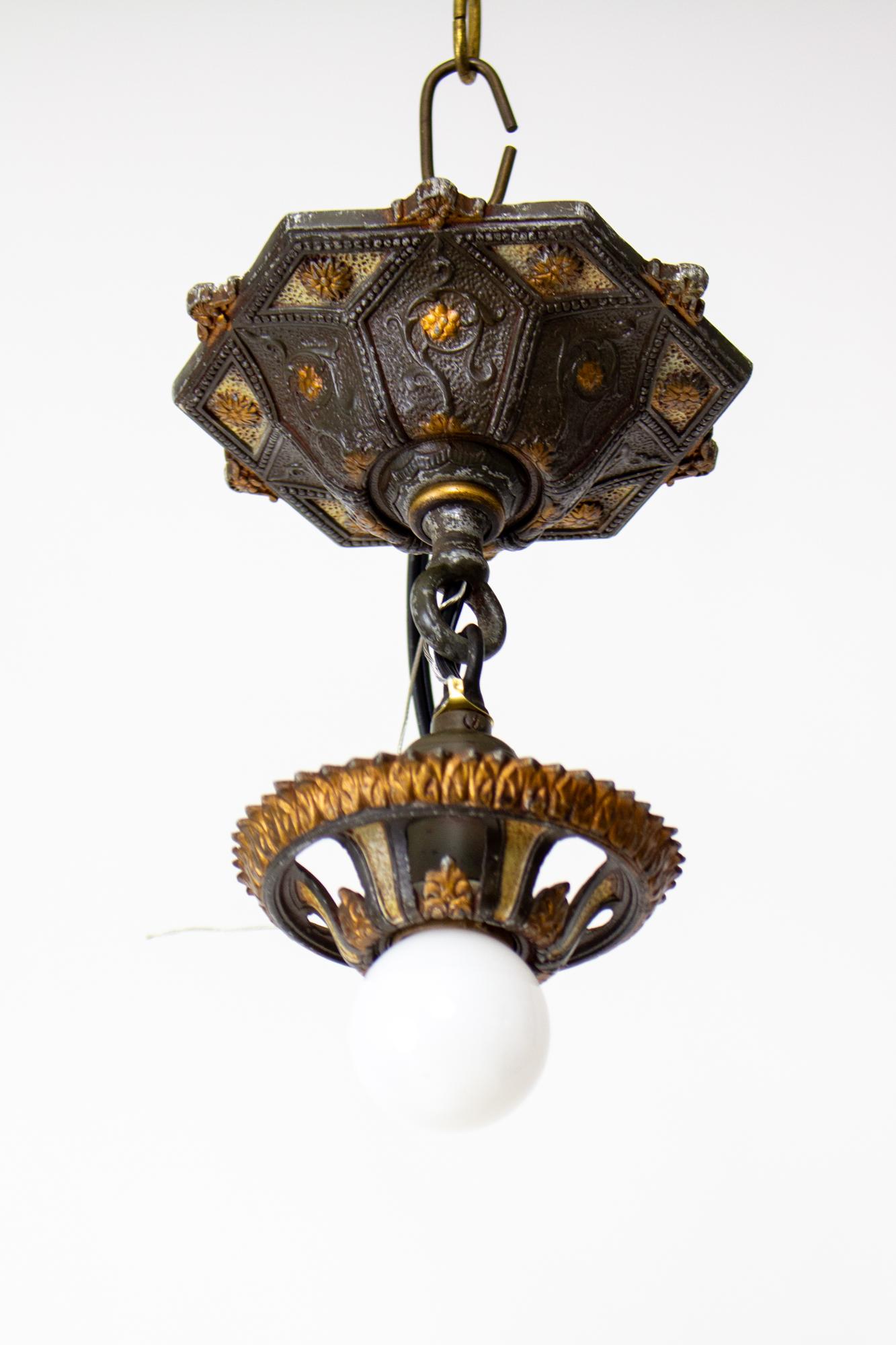 1920's polychrome Riddle polychrome pendant light. A single exposed bulb with polychrome canopy and socket cover. Original paint has been cleaned and protected, 
 and features black and metallic gold. Made from die cast aluminum with brass fittings.