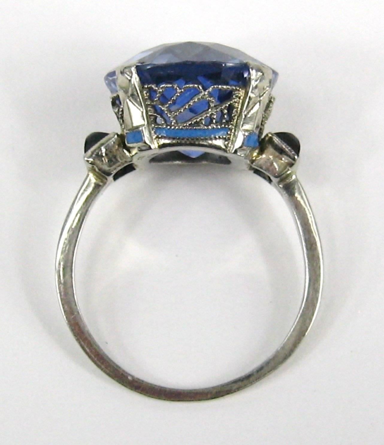 1920s Large 11.51 Carat Blue Synthetic Sapphire set in a stunning 14K White Gold Setting. Flanked by 2 Cabochons. Stone measuring 13.10 x 13.29 x 8.35 mm per GIA certification. Color Blue.  Cutting Style is Brilliant Cut. Ring is a 7.5 and can be