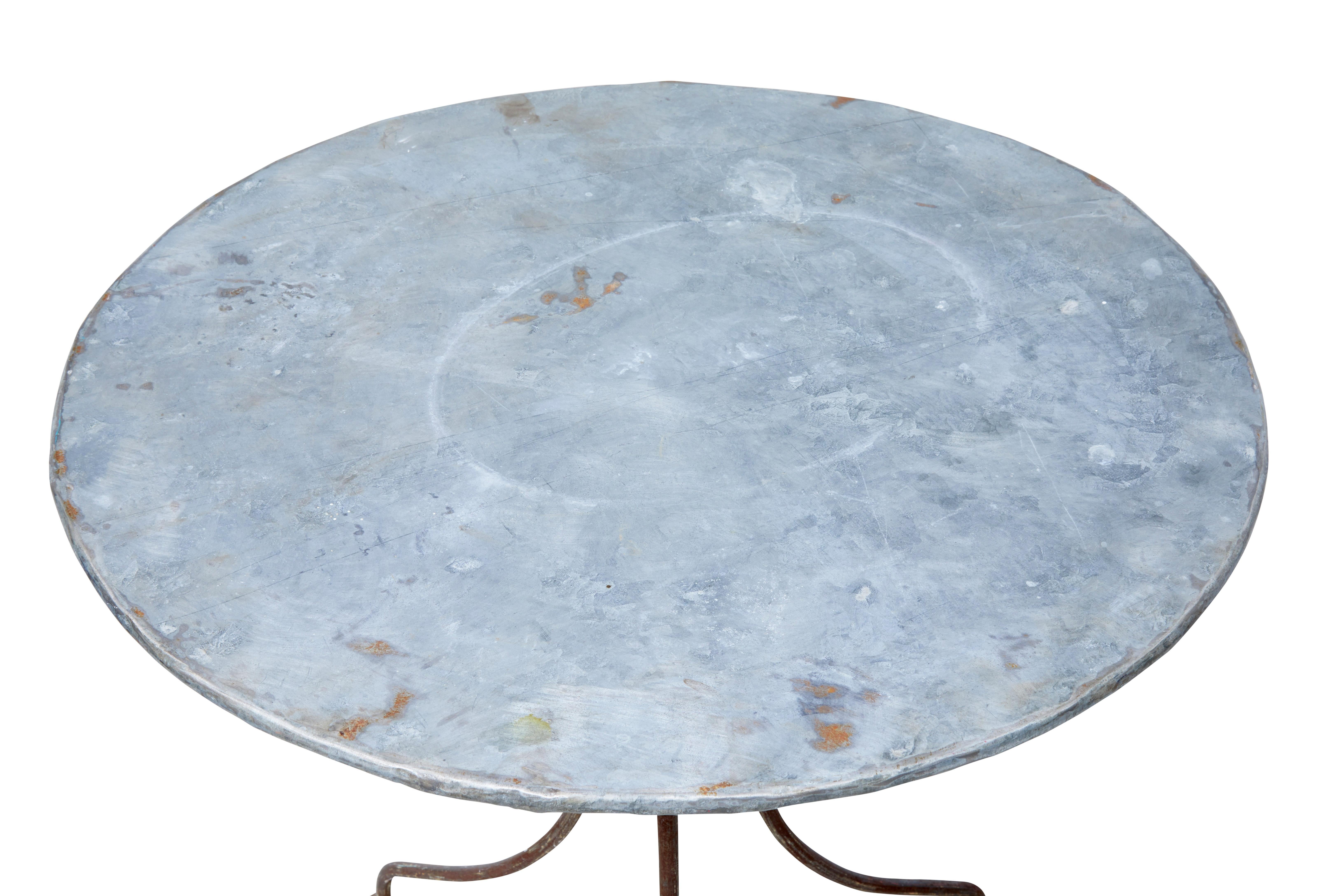 Good quality round metal occasional table from the 1920s.

Galvanised round top and steel shaped base. Ideal for use as a garden table or lamp table.

Traces of original paint to base, obvious signs of use to the top surface.