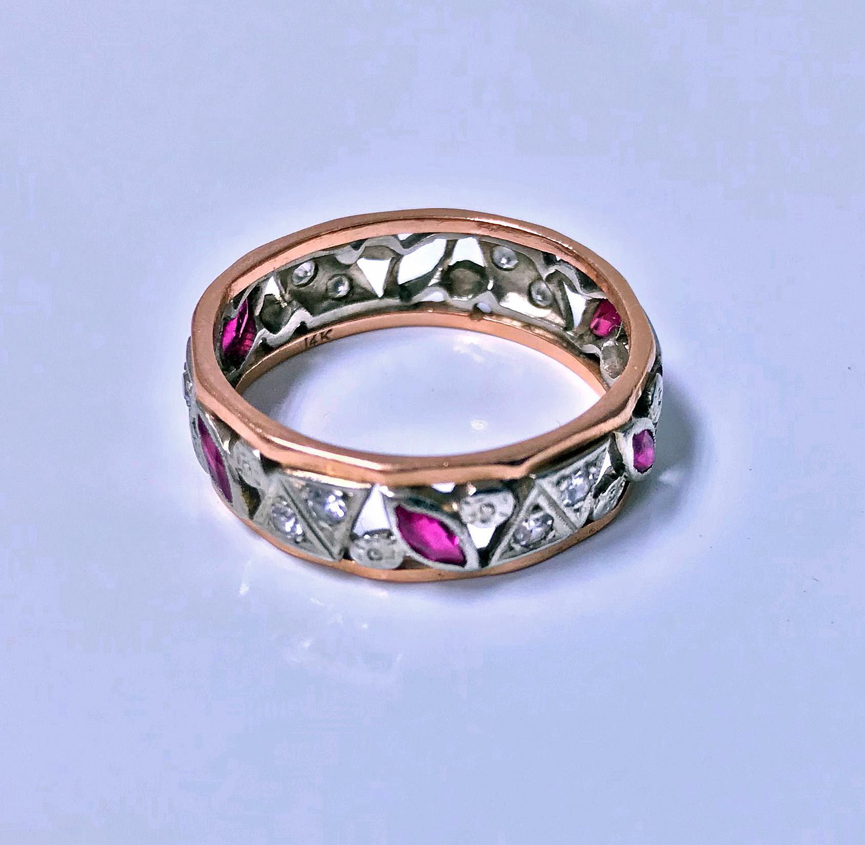 1920's Ruby and Diamond 14K pink and white gold Ring. The Ring of band form with open white gold pierced rosette miilligrain and bezel set small single cut diamonds and marquise rubies between solid pink gold border surrounds. Stamped 14K on