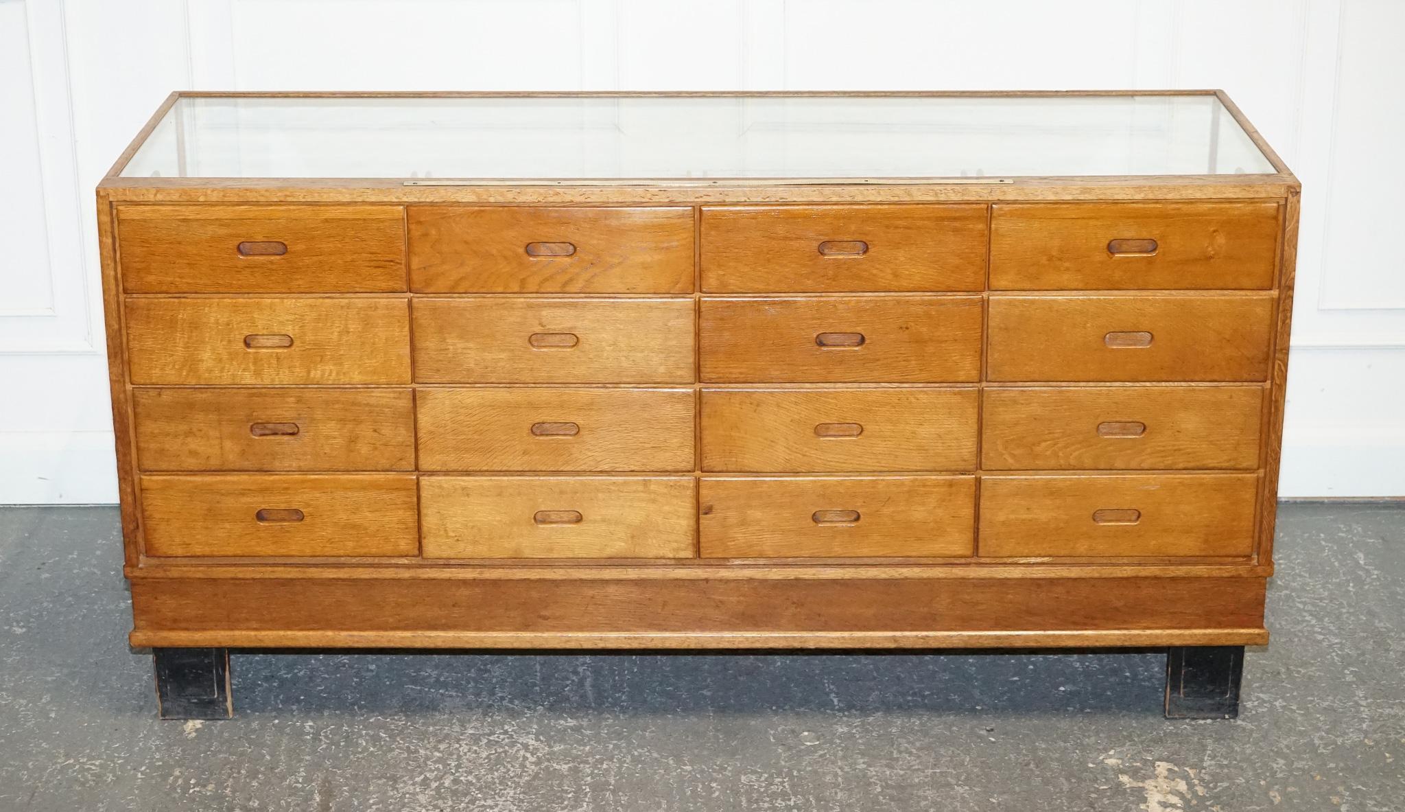 
Antiques of London



We are delighted to offer for sale A Stunning c. 1920 Ruddock & Co. Oak 16-Drawer Haberdashery Shop Display Counter.

 A true testament to craftsmanship and quality. This beautiful piece, with its solid oak construction and
