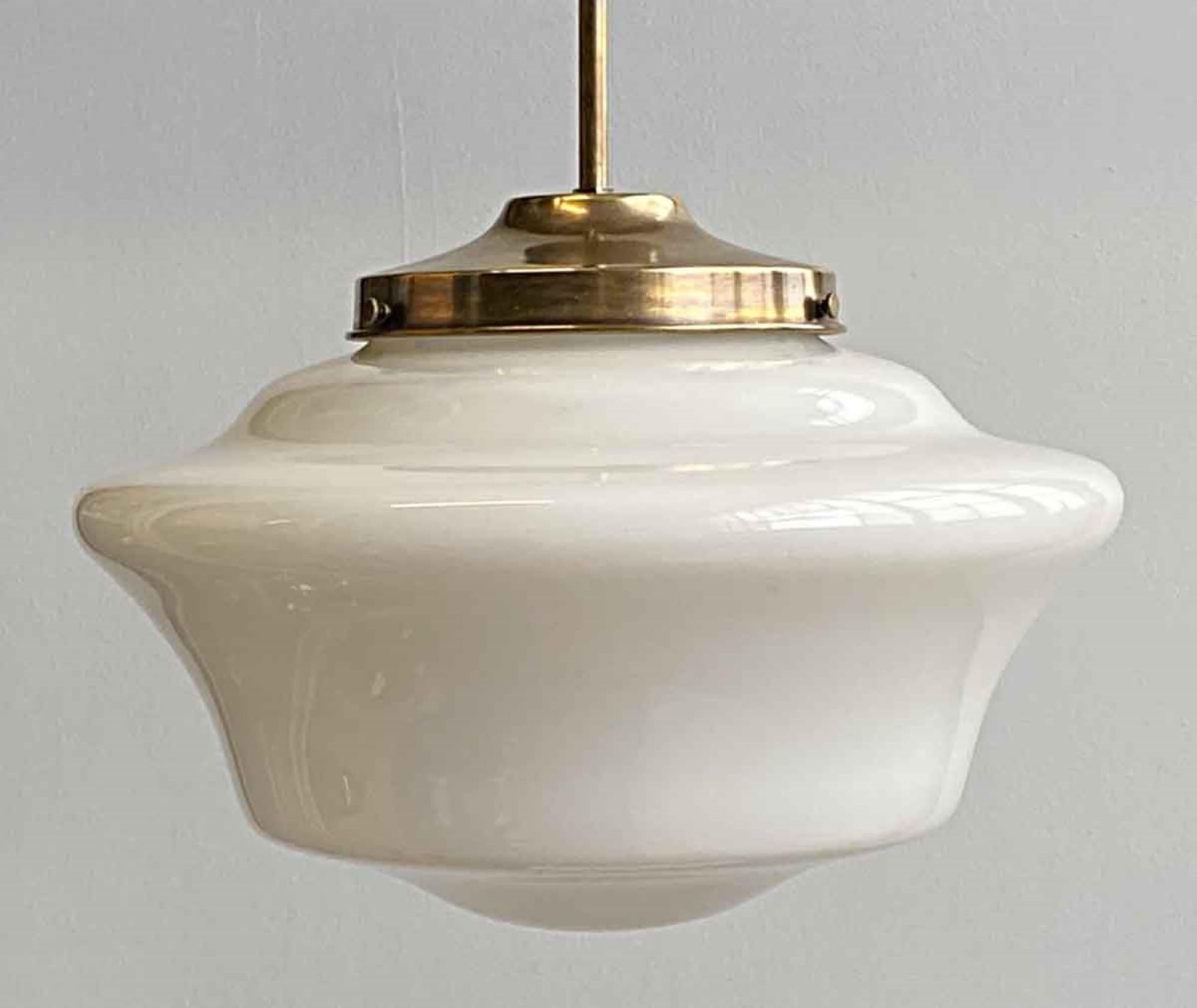 1920s white milk glass parlor style schoolhouse globe fitted with a newly made brass pole fitter and hardware. You can choose between a pole or chain fitter with a patina brass or brushed steel finish. Small quantity available at time of posting.