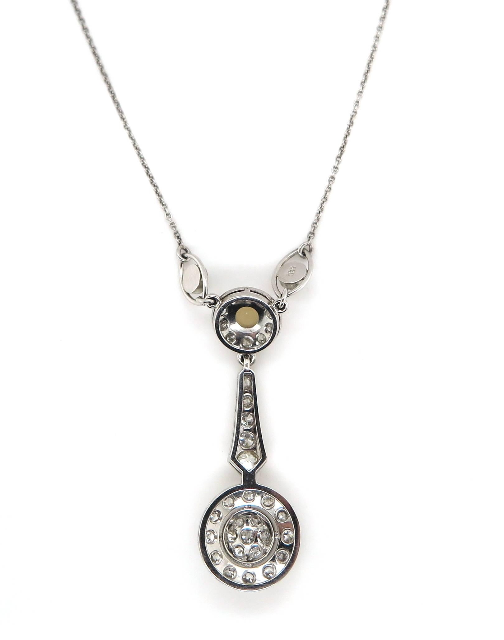 Featuring a unique antique seed pearl diamond pendant set in three vintage seed pearls and 34 Old European cut diamonds totalling to 0.95 carat crafted in 14K White Gold. The unique design is pertinent to the 1920's era depicting pierced decorated