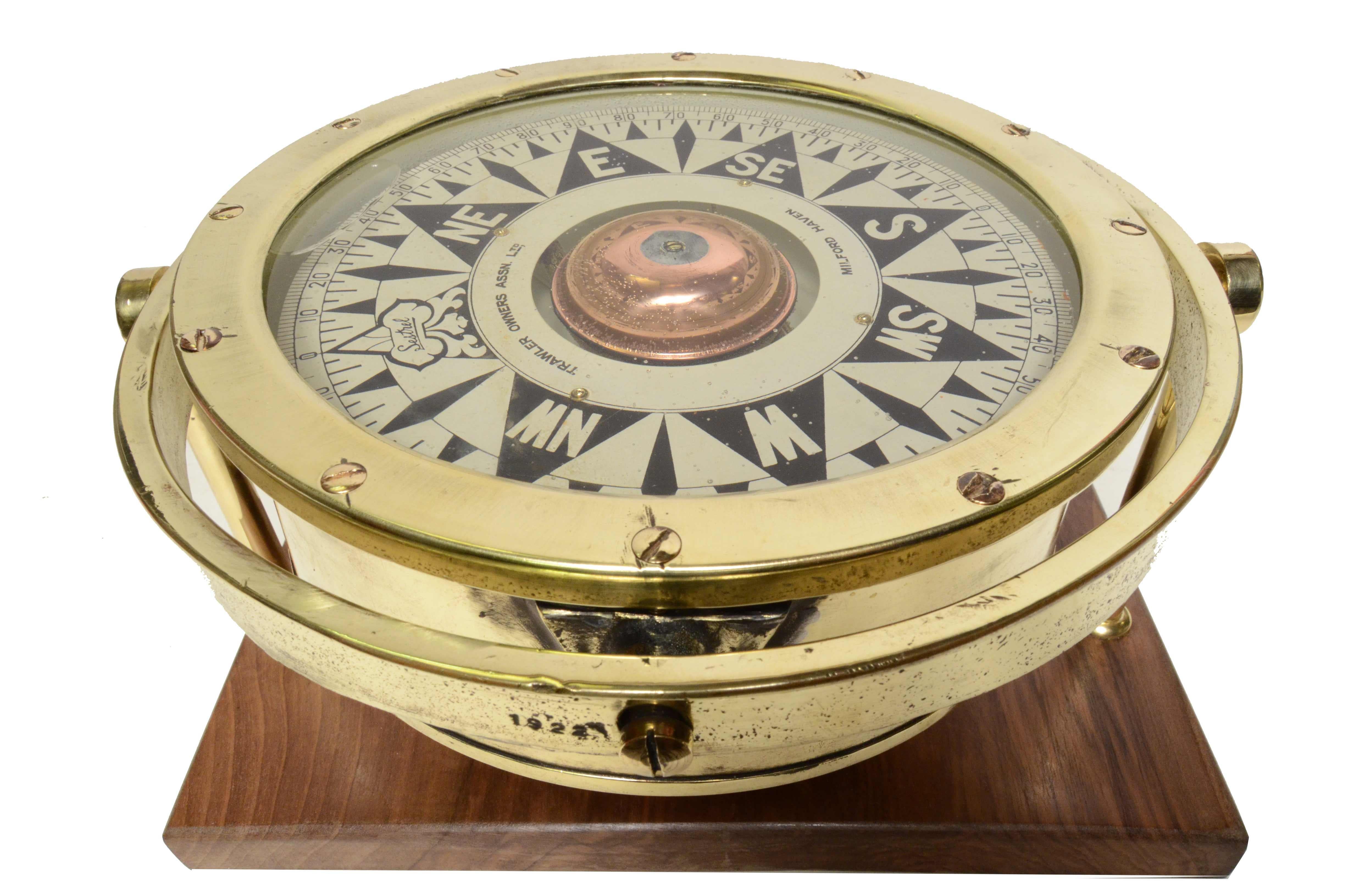 1920s Sestrel gimbal mounted liquid filled nautical compass
made for Trawler Owners Asson. Ltd Milford Haven, a trawler owners association founded in 1917. The compass is mounted on a bespoke walnut board with brass mounts. The compass consists of