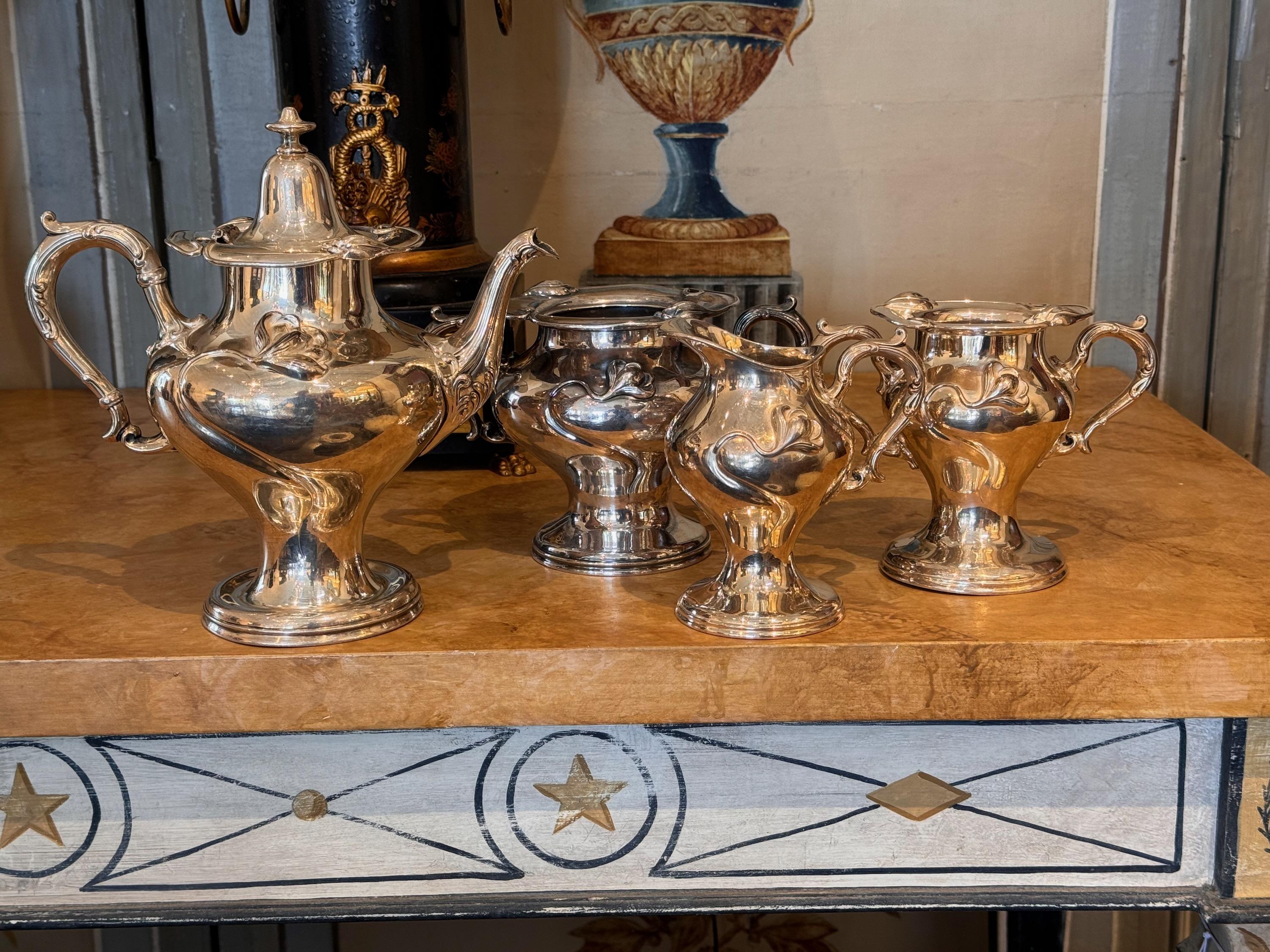 An art nouveau influenced design. A lovely set. Cream, sugar, waste pot, and pitcher.