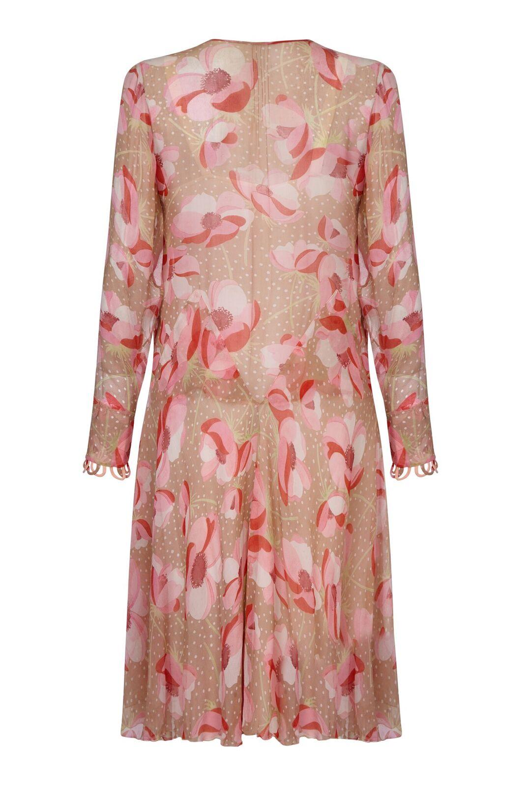 This charming 1920s silk chiffon floral print dress is delicate, feminine and in beautiful vintage condition. The sheer chiffon fabric hosts a bold poppy design in soft pink shades over a warm fawn backdrop and has an air of understated modernity.