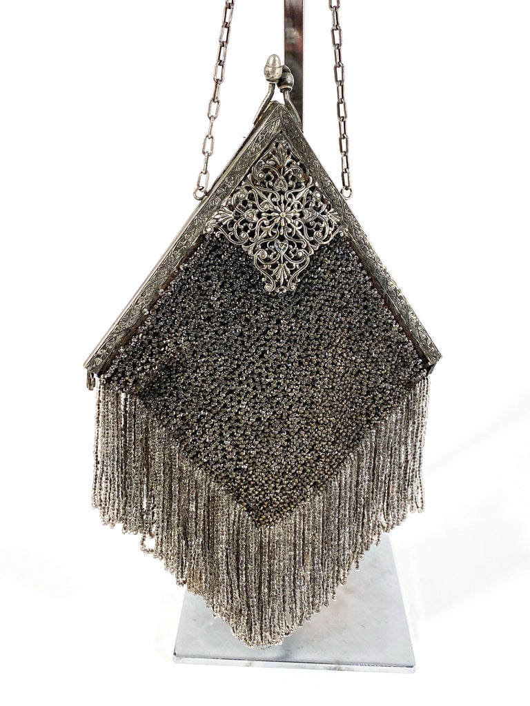 1920s Handmade Art Deco silver beaded hand bag with filigree bag clip and frame. The body of the purse is lined in a satin. 