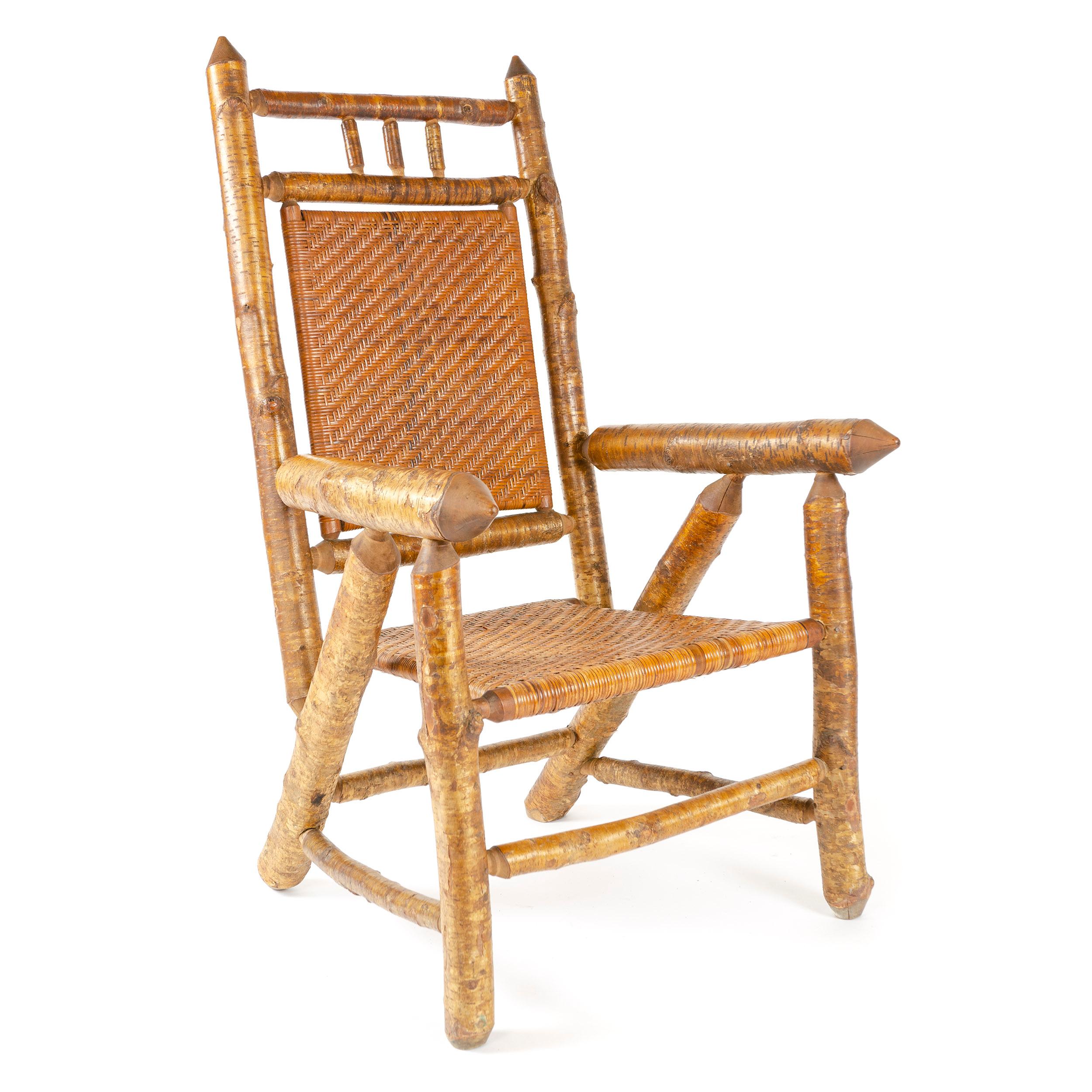 An uncommon, substantial rustic armchair built of Silver Birch with a double-caned seat and back.

'The frames are built of the beautiful Silver Birch, which grows only in a small portion of the Adirondack Forest, the Great north Woods. The