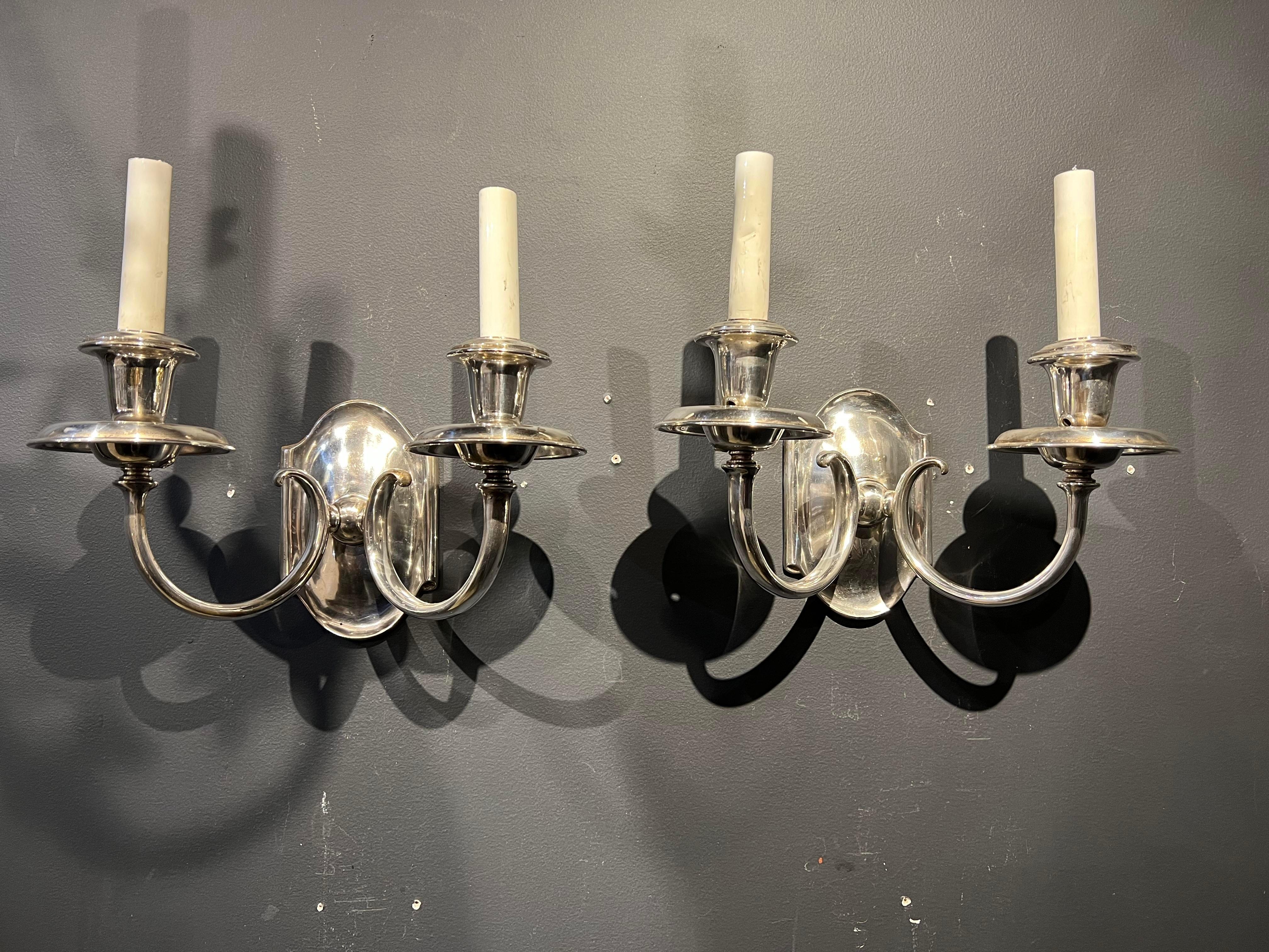 A pair of circa 1930’s Caldwell silver plated sconces with two lights.

Dealer: G302YP