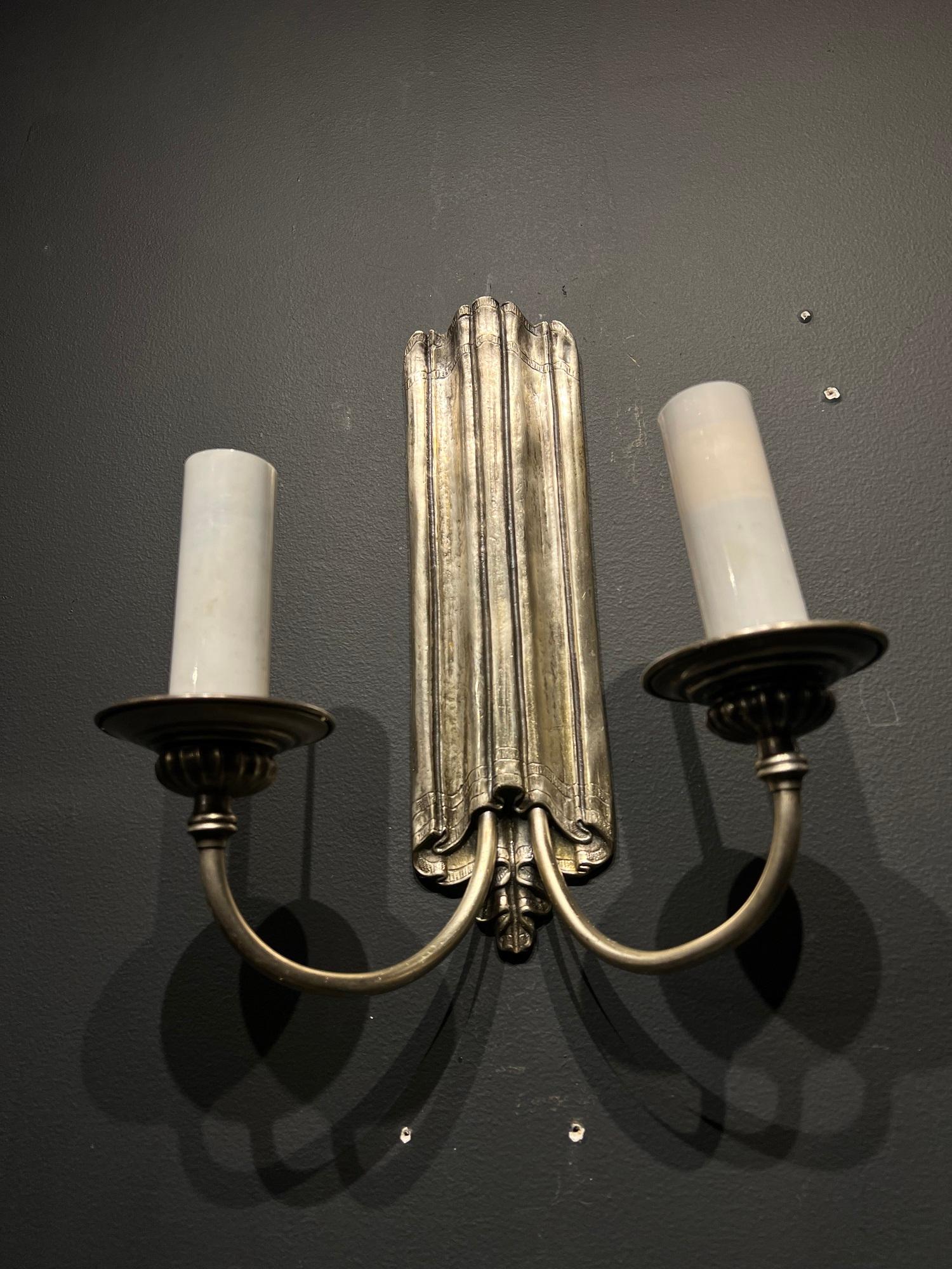 A pair of circa 1920’s Caldwell simple silver plated sconces with two lights