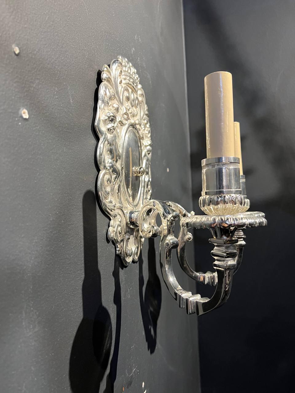 A circa 1920's Silver Plated Sconces with cherubs design and two lights